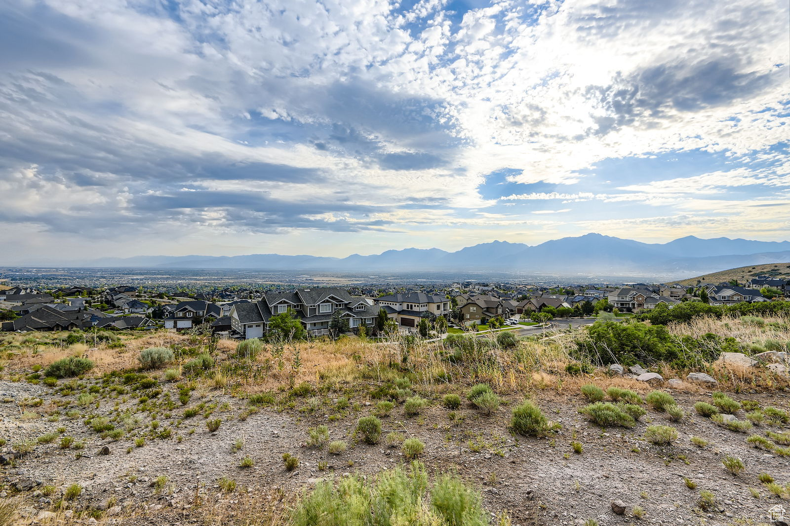 Build your dream home on this private, view-filled lot in Herriman! Just 3 blocks from Blackridge Reservoir-kayak, swim, or relax on the beach. Hike or bike straight from your backyard with access to Secret Canyon Trailhead. Enjoy breathtaking views of the Wasatch Front, Salt Lake Valley, and sparkling city lights. No back neighbors-lot backs to Herriman City land with no homes on either side. Easement allows home to face valley views. Minutes to shopping, dining, parks, rodeo, Yellow Fork equestrian trails, Zion Bank Stadium & Butterfield Canyon. Sunsets hit earlier here-lot sits above the inversion. Don't miss this rare gem!