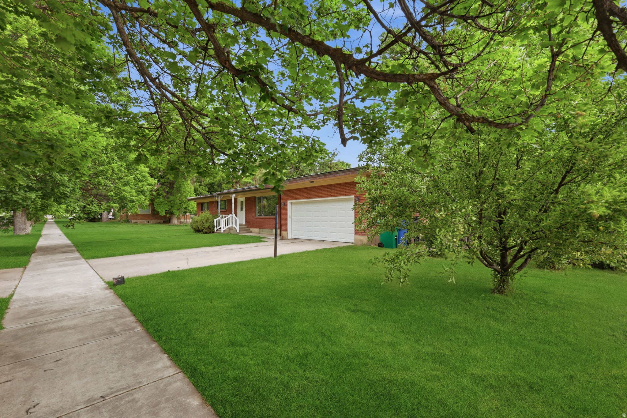 Freshly remodeled 6-bedroom, 3-bathroom home in Wellsville offering space, functionality, and modern updates on a .40 acre lot.  The main level features two spacious living areas, three bedrooms, two full bathrooms, and an updated kitchen with beautiful light wood cabinetry. Recent improvements include new sheetrock, textured walls and ceilings, fresh interior paint, and updated door and cabinet hardware. The fully finished basement provides exceptional flexibility with a second kitchen, large family room, full bathroom, three generously sized bedrooms, and cold storage-ideal for multi-generational living, guests, or additional entertaining space. Enjoy the private, fully landscaped backyard complete with mature shade trees, fruit trees, and grapevines, creating a peaceful outdoor retreat. This move-in-ready home offers room for everyone. Schedule your private showing today!