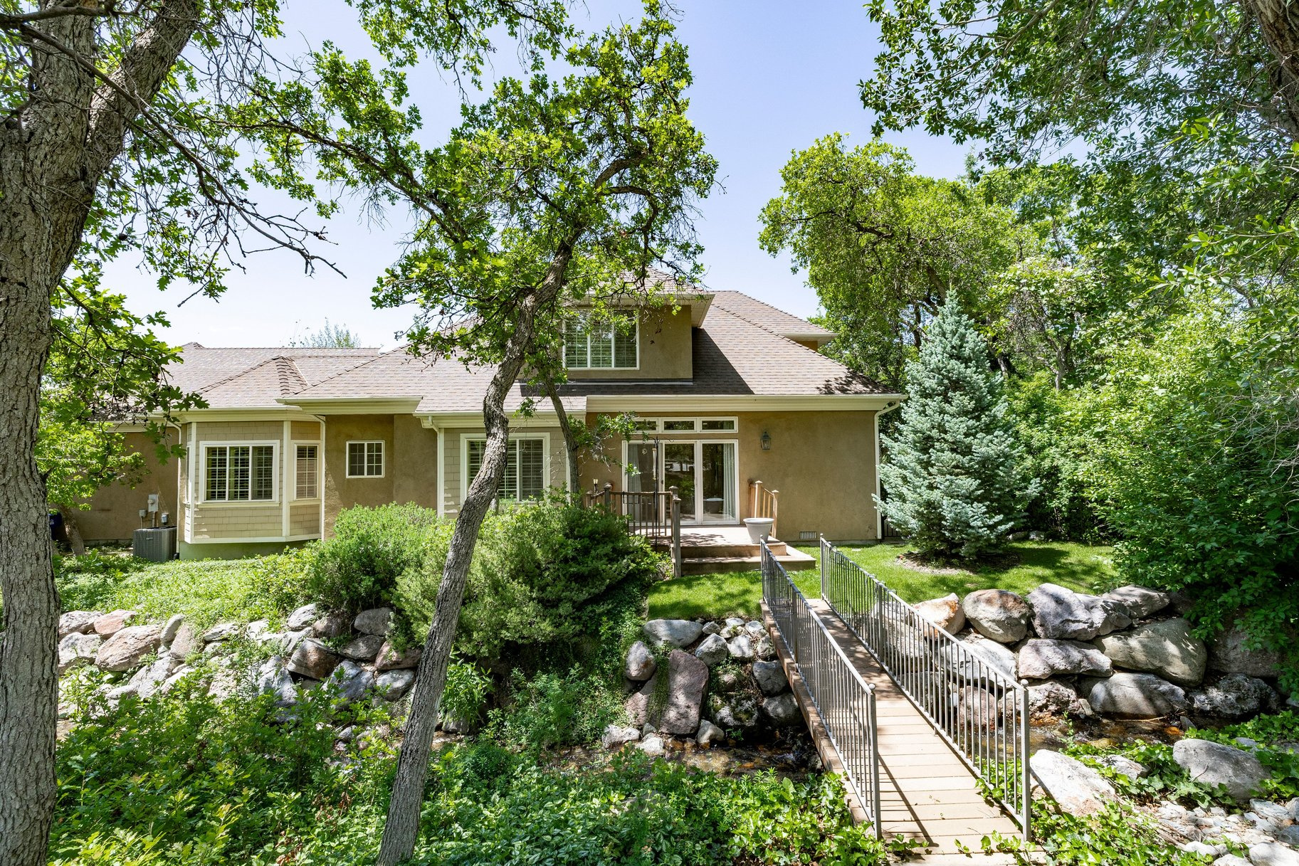 Nestled behind a private electric gate in the coveted Upper East Bench of Cottonwood Heights, this exceptional two-story home offers 3,286 square feet, four bedrooms, 3.5 baths, and a large two car garage on a beautifully landscaped .39 acre lot. Mature trees, mountain views and a soothing seasonal stream from Deaf Smith Canyon create a peaceful and private setting. The home features a very desirable main floor primary suite, dedicated office with built-ins, two fireplaces, plantation shutters and a large, open kitchen with granite counters, gas range and adjoining dining spaces. Upstairs, spacious bedrooms with walk-in closets provide abundant storage and comfort. Ideally located just minutes from Big and Little Cottonwood Canyons with world-class skiing, hiking , and outdoor adventures. A rare opportunity to purchase separately or together with adjoining 3450 Hidden Oak Drive, a 5,300 square foot luxury residence to create a extraordinary multigenerational estate or family retreat.