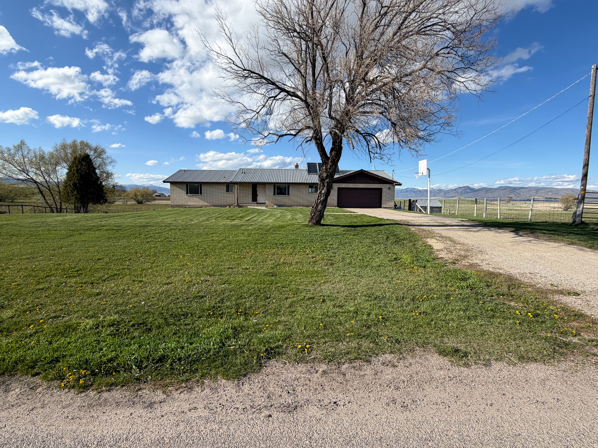 Beautiful, spacious rambler in the lovely town of Paris, ID! Situated near the north edge of town on a slow-going road, on a large, usable 1 acre lot, this is the one you've been waiting for! The kitchen/dining/living rooms are perfect for entertaining, and you'll love the size of the large primary bedroom with its walk-in closet and attached bathroom. The bedroom even features a second access to the north deck, with its peaceful valley and mountain views. Walkout basement has tons of natural light with access directly out to the backyard and a separate entrance from a staircase within the garage, suited well for multi-generational living, or even renting out one floor and living in the other! Basement has plenty of room to add second kitchen in massive family room, and a third bathroom is already fully rough-plumbed downstairs. This lower floor also features two storage rooms and a finished office space, so more bedrooms could be added if desired, or plenty of space to have dedicated to your hobby/craft/office room! Garage is well oversized, so you can park that extended pickup with no issues, and even have workshop/storage space, too! Hassle-free yard with automatic sprinklers really make this one too complete to pass up. Come see it today!!