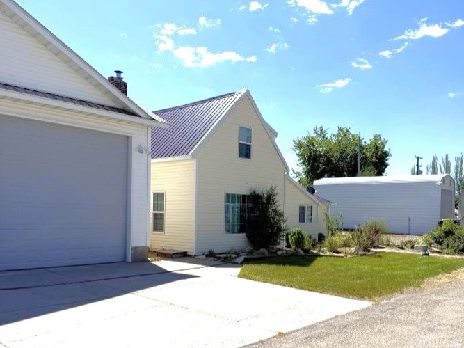 DON'T MISS OUT on this beautiful, upgraded home with space for all your recreational toys. Need a place to store your boat or RV? This property has a 12 x 36 building with an 11x12 ft door. Need a garage with doors that are wide and tall? This property has a 30 x 30 garage/shop with doors that are 10x12 and 12x12. NEW flooring in the dining room, kitchen, office, and basement. NEW countertops in the kitchen. Large living room with NEW wood fireplace. The kitchen/dining area has french doors out to the covered patio. Bonus room/office off the kitchen that could be made into a 4th bedroom. Downstairs is a family room and bedroom with a walk-in closet. Call the listing agent today for a tour!!