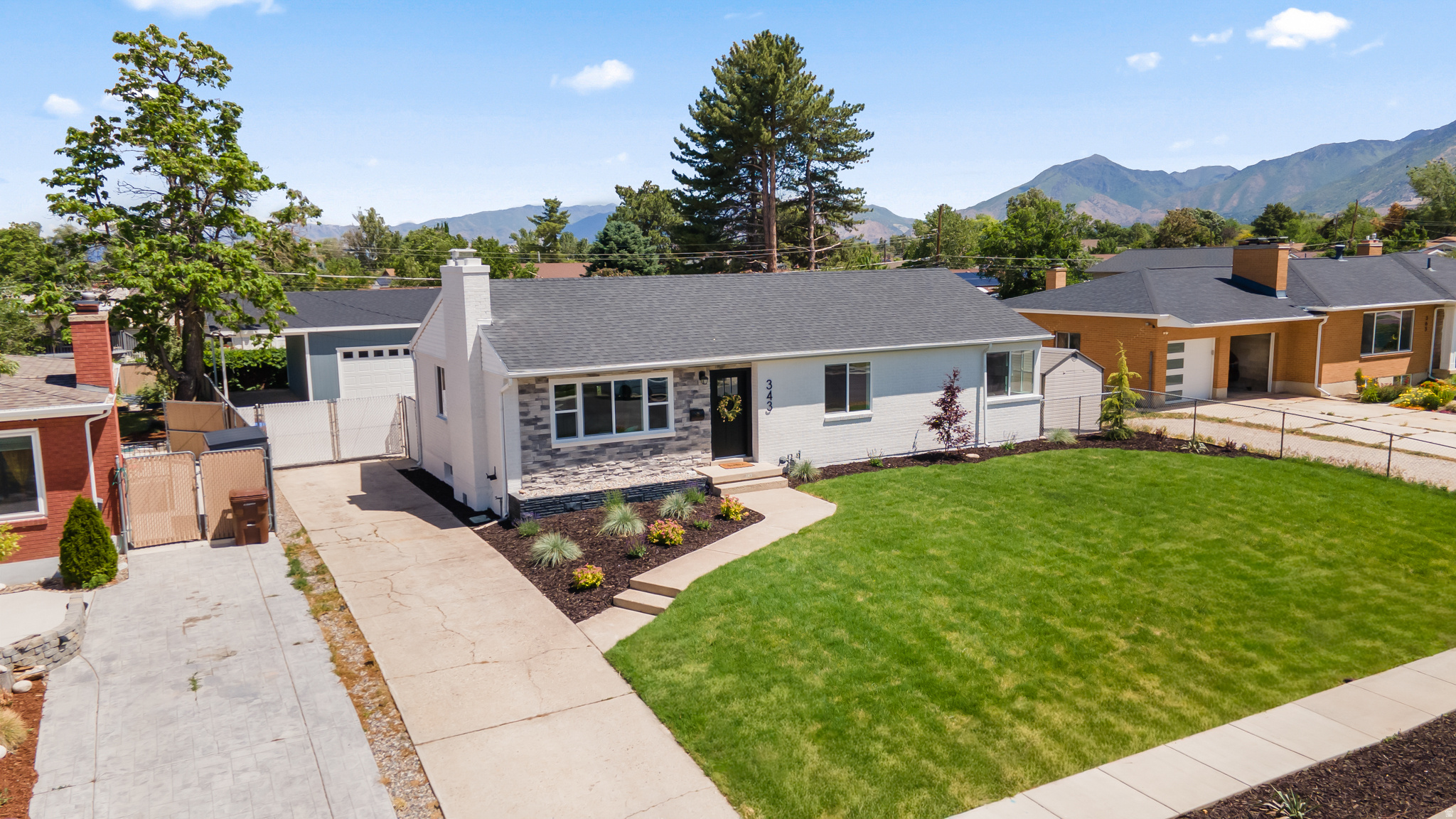 Beautifully updated 4-bedroom, 2-bathroom home offering the perfect combination of modern upgrades, flexible living space, and an exceptional lot. Spanning two levels, the thoughtfully designed layout includes a bright and welcoming main floor along with a fully finished basement, providing plenty of room for everyday living, entertaining, and hosting guests.  The main level features refinished hardwood floors, abundant natural light through oversized windows, and a beautifully remodeled kitchen with shaker-style cabinetry, solid-surface countertops, stainless steel appliances, and a dedicated dining area. Two spacious bedrooms and a full bathroom complete the main floor.  Downstairs, the finished basement expands the living space with a large family room, two additional bedrooms, a second full bathroom, and plenty of flexibility for a home office, gym, media room, or play area.  Outside, you'll find a fully fenced backyard designed for both relaxation and functionality. Enjoy summer evenings under the covered patio, gather around the fire pit, or take advantage of the expansive lawn with room to play, garden, or entertain. A rare oversized detached garage/shop provides ample space for vehicles, storage, hobbies, recreational equipment, or a workshop setup.  Situated in an established neighborhood with breathtaking mountain views, this move-in-ready home offers convenient access to schools, parks, shopping, dining, and major commuter routes.