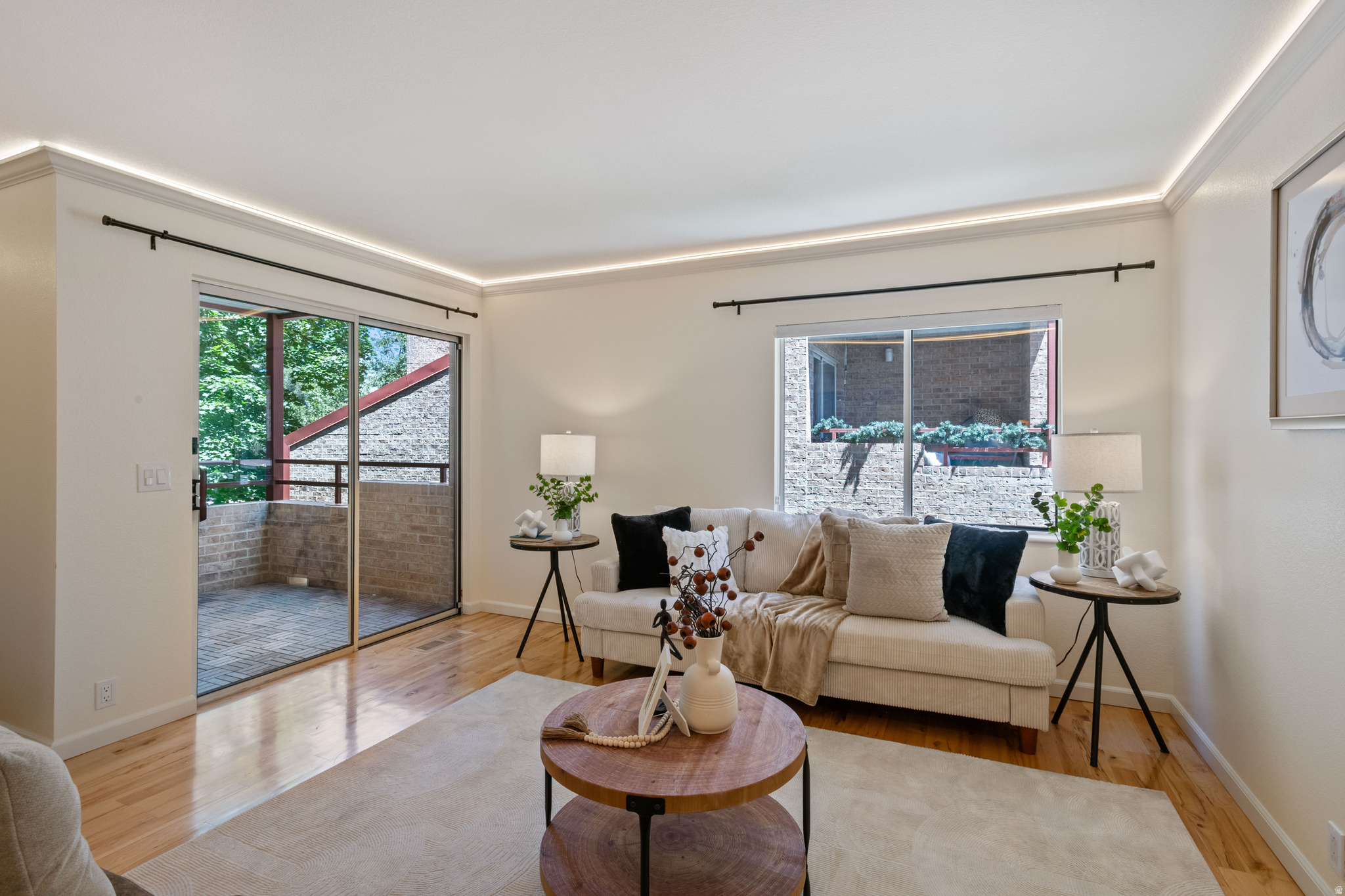 Impeccable condition meets curated quality in this stunning Holladay condo. Every inch of this 2-bedroom residence has been meticulously maintained and beautifully upgraded with high-end finishes and smart-home features. The well-appointed kitchen features a premium induction range/oven (2022), a newer refrigerator (2020), and a new dishwasher (2023)-all flowing seamlessly into an open-concept dining and living space equipped with smart light switches, a smart thermostat, and custom smart LED lighting.  Luxury meets comfort with radiant heated floors stretching through both the kitchen and the spa-like bathroom oasis, which also boasts a standalone soaking tub, a separate custom shower, and a heated towel rack. Brand-new premium carpet (2026) runs through the bedrooms, while expansive sliding glass doors lead to a private covered deck with peaceful mountain views. Enjoy ultimate peace of mind with completely updated mechanicals, including a new HVAC system (2022) and a new water heater (2024). Fantastic location across the street from Trader Joe's and Magnolia Bakery and steps to parks, wetlands, Holladay Lions. Located in a secluded, manicured community with a pool and covered parking, this turn-key home offers maintenance-free living at its absolute finest.