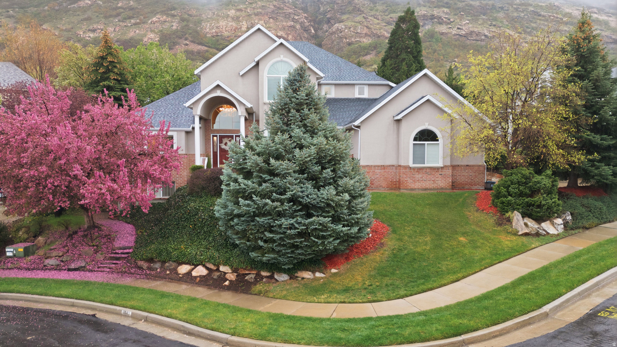 Located in a well-manicured subdivision on the east benches of Salt Lake County, this stately 6,200-square-foot two-story home offers exceptional space, comfort, and location. Situated on nearly a 1/3-acre lot, the home features vaulted ceilings, a main-level primary suite, and a spacious kitchen that opens seamlessly to the family room-perfect for both everyday living and entertaining. Enjoy beautiful mountain views and the convenience of a junior suite upstairs. Additional highlights include a three-car garage, a fully landscaped yard with a private backyard and patio, and a walk-out basement with four bedrooms and 3.5 bathrooms. Ideally located near Hidden Valley Country Club, with direct access to the Bonneville Shoreline Trail for hiking and biking, as well as close proximity to several canyon trailheads. This home combines size, setting, and location to deliver exceptional value for the discerning buyer.