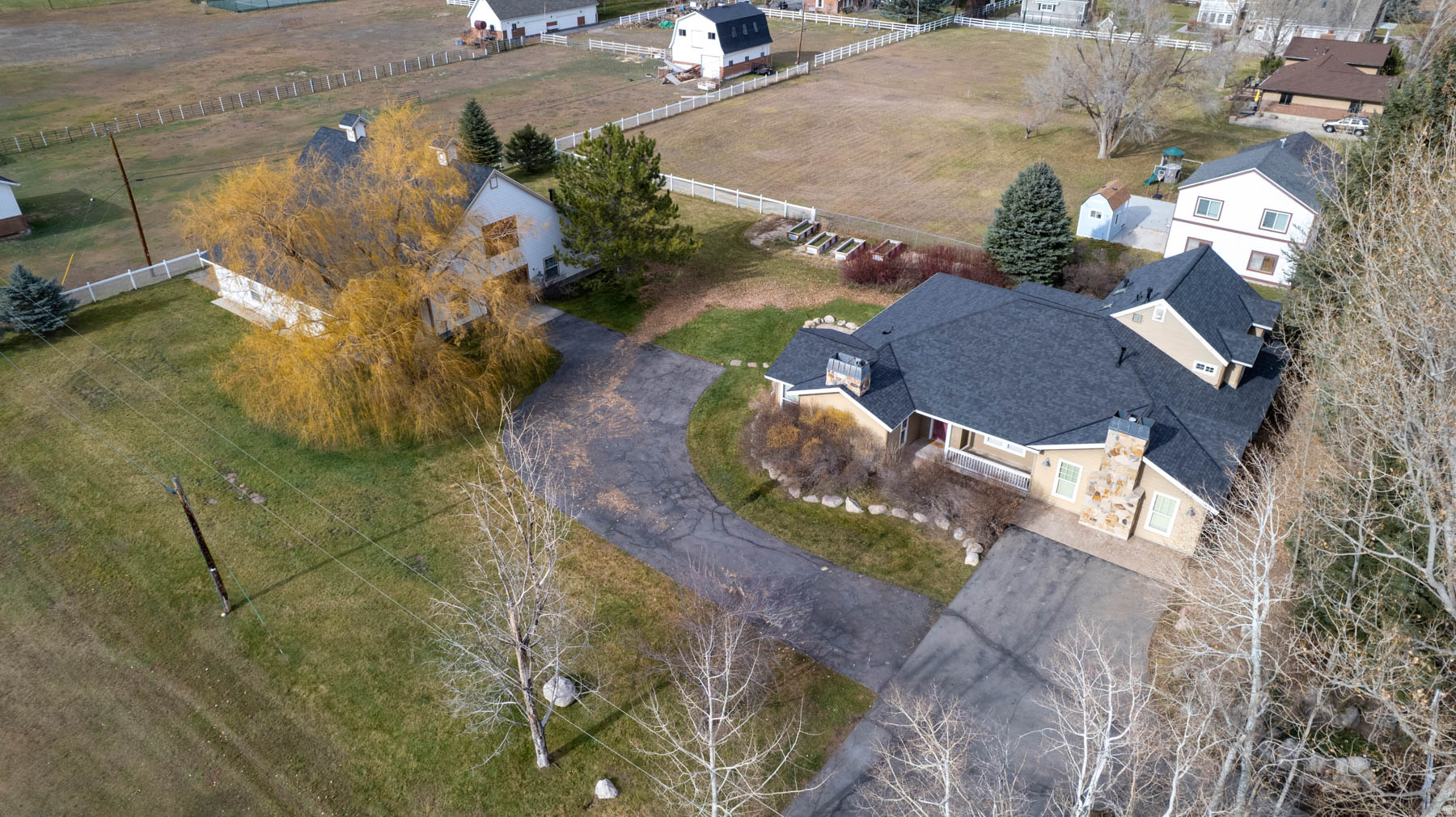 Rare find in Midway!!!! 1.3 acres of pristine property. The location of this house and barn make the perfect getaway in one of the most unique mountain towns in Utah. Just minutes away from World class skiing , golfing , and fishing. The property is horse property, and has the space for any activity the new buyer would like to add, like a pool, or tennis court, or pickleball court. The views up Snake Creek Canyon and also Mount Timpanogas are stunning. This cozy and comfortable 5 bedroom home has an open kitchen with plenty of space for family parties. Two comfortable sized family rooms with two gas fireplaces.  Master bedroom is on the main level, with a great view of the mountains from the master bathroom. The heated barn/rec building can hold 8 to 10 cars. The building has living quarters in it, with one bedroom, one 3/4 bathroom, kitchenette and living area. RV Pad on West Side with more covered parking or storage on north side. Two large storage rooms inside as well. Both buildings have brand new roofs in 2025. This property is priced below 2025 appraisal. Come take a look, and you'll fall in love with the property, location, and Midway.