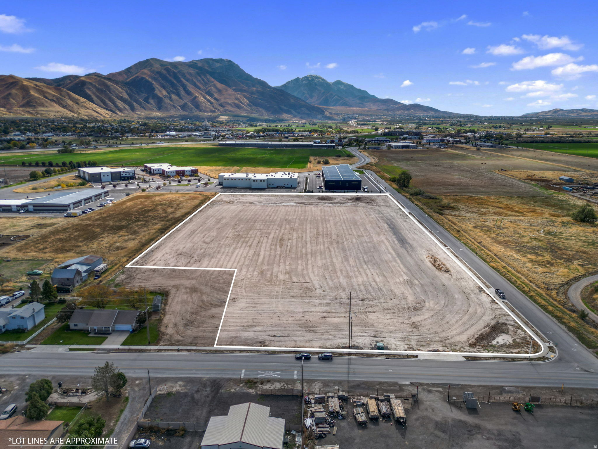This strategically located parcel offers excellent access to Interstate 15 and the Payson CBD, making it ideal for a variety of commercial uses including office buildings, light industrial or manufacturing, and research and development facilities. The parcel is surrounded by numerous established businesses, providing the buyer with a unique opportunity within this high-demand corridor. An existing residence is located on the property and may be retained as an income-producing investment or removed to accommodate additional development. The property also offers flexibility for potential subdivision into smaller parcels, subject to city approval.  Significant site preparation has already been completed, including the import and compaction of structural fil to create a large, level buildable pad. This work substantially reduces development timelines and upfront costs, positioning the site as a near shovel-ready opportunity for a range of commercial uses. Key utilities are readily available, with water, sewer, electrical, and fiber optic infrastructure located on or immediately adjacent to the property, allowing for efficient connections and flexible site planning. Combined with the parcel's size and strategic location, these improvements provide a strong foundation for future development and long-term value.