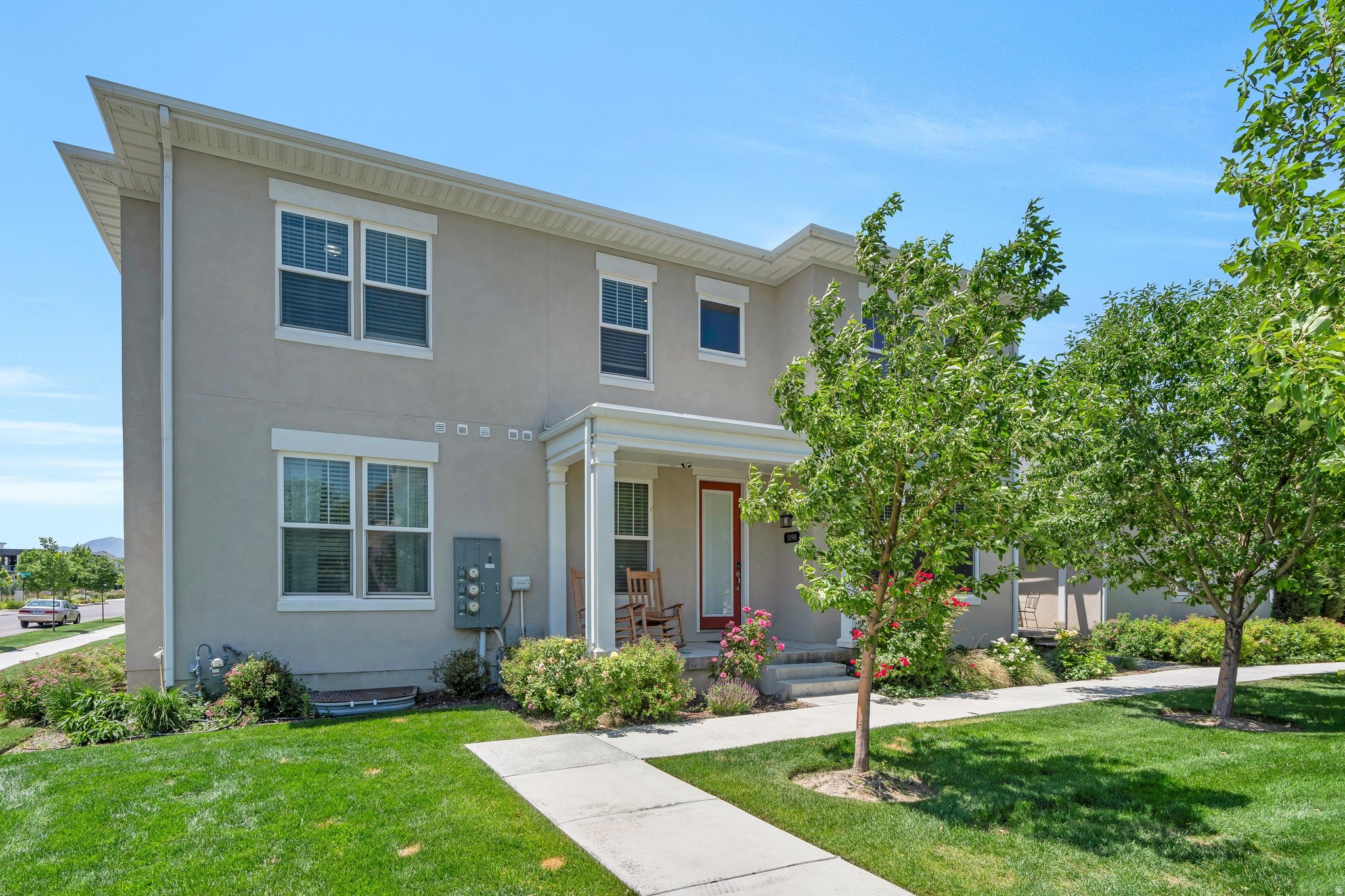 Welcome to this beautifully situated Daybreak townhome, offering premium lot placement, incredible views, and a thoughtfully designed floor plan that blends comfort, functionality, and style. Positioned to capture views down both streets, this home enjoys an open, airy feel and a setting that is hard to find.  Step inside to a stunning great room featuring soaring ceilings and expansive windows that flood the home with natural light. The open-concept layout creates an inviting space for both everyday living and entertaining.  The kitchen is beautifully appointed with rich, tall cabinetry, elegant glass display cabinets, granite countertops, stainless steel appliances, and a gas range. Adjacent to the kitchen, the dining room features French doors that open to the patio and backyard, creating the perfect indoor-outdoor flow for gatherings, barbecues, and entertaining guests.  The main-level primary suite offers the convenience of single-level living and features a spacious ensuite bathroom complete with a double vanity and large walk-in shower. An added bonus is the dedicated laundry area within the primary suite, in addition to a second laundry room located downstairs for maximum convenience and flexibility.  The lower level provides additional living space and a beautifully appointed bathroom featuring a large soaking tub, creating a spa-like retreat for relaxation.  Located in the award-winning Daybreak community, you'll enjoy access to Oquirrh Lake, over 30 miles of walking and biking trails, community pools, fitness facilities, parks, playgrounds, sports courts, community gardens, and year-round events. Shopping, dining, entertainment, and TRAX are all just minutes away.  With its premium location, abundant natural light, stunning views, and desirable main-level living, this exceptional townhome offers the perfect opportunity to enjoy the Daybreak lifestyle at its finest.
