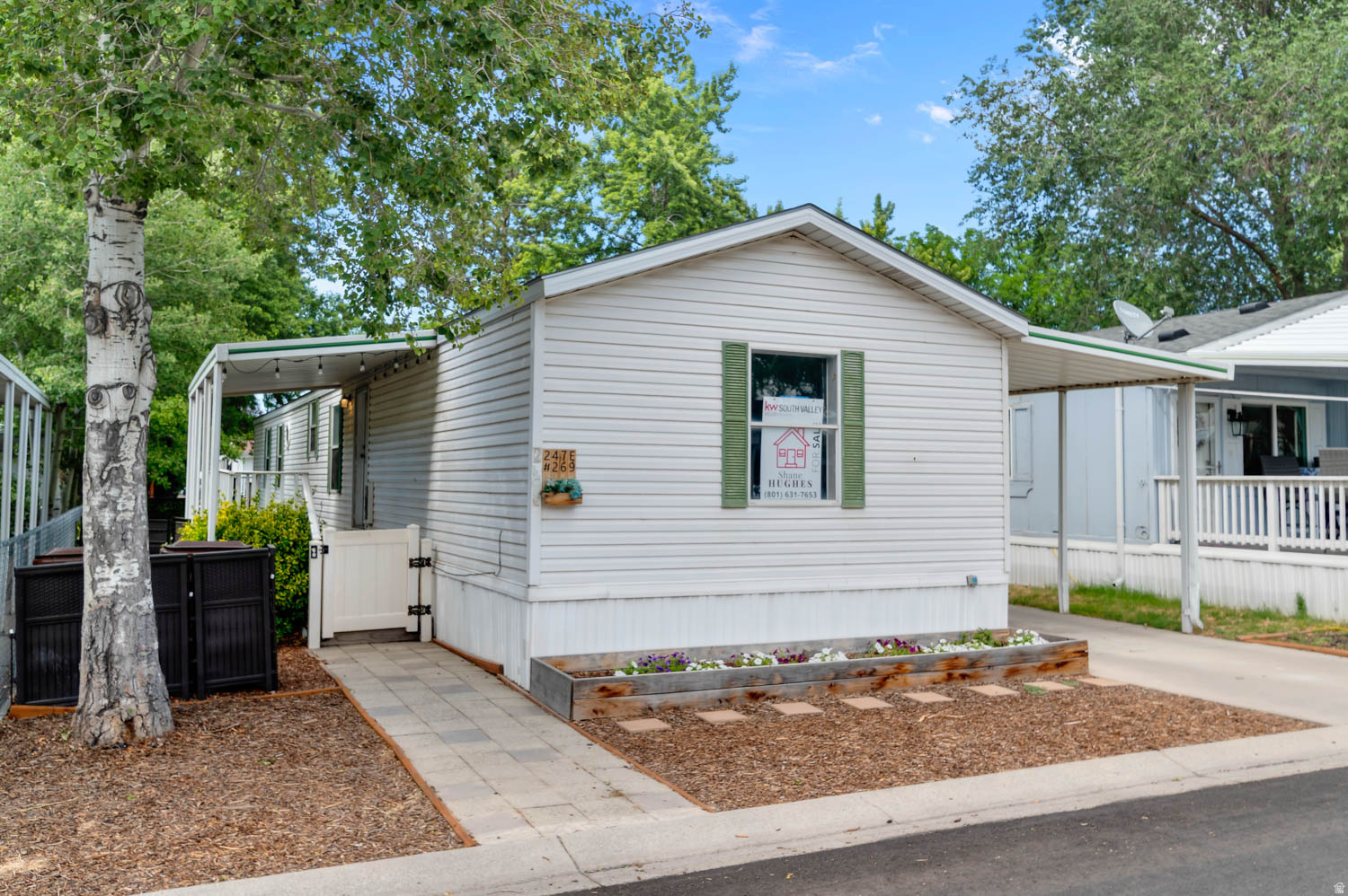 Welcome home to this beautifully maintained and thoughtfully updated residence in one of the area's most desirable manufactured home communities. Ideally located near TRAX, shopping, dining, walking distance to both elementary and middle schools,  and everyday conveniences, this home offers both comfort and accessibility. Recent improvements provide peace of mind and modern appeal, including updated flooring. Fresh interior paint, new furnace and central air conditioning, updated lighting throughout, and remodeled bathroom features. Outdoor enhancements include a rebuilt front porch and steps, raised garden boxes, an extended concrete driveway, and a large 8' x 8' storage shed. Residents enjoy outstanding community amenities including a swimming pool, playground, picnic area, and beautifully maintained grounds. Whether you're looking for low-maintenance living or a convenient location close to transportation and shopping, this move-in-ready home is a fantastic opportunity!!