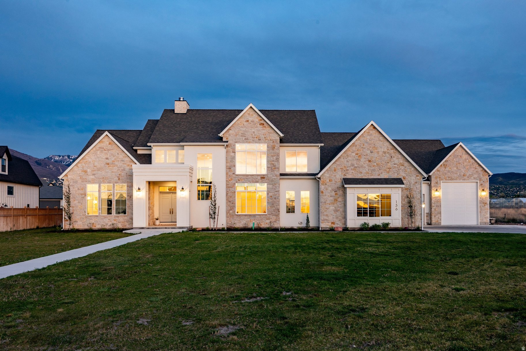 Stunning custom 2023 estate in West Bountiful's coveted Highgate Estates. Nearly 6,000 sq ft above grade with 5 beds, 5.5 baths on a full horse-property acre. Wide- plank white oak floors, marble counters and showers, and a breathtaking two-story natural stone wood-burning fireplace anchor luxurious living spaces. A chef's kitchen with 60" Wolf gas range and butler's pantry sits at the heart of the home, while the theater/bar/game/gym room is built for entertaining. The spa-like primary suite features a fireplace, dream bath, and enviable closet. Four upstairs bedrooms include two en-suites. A standout finished, heated and AC'd 2,900 sq ft garage with 8, 10, and 12-ft overhead doors fits a pickleball court, warehouse, or whatever you can imagine. Room for a pool, ADU, or barndominium. Enjoy sunset views, east mountains, and top-rated schools. Don't miss this legacy estate at 156 Hammersmith Cir, West Bountiful.