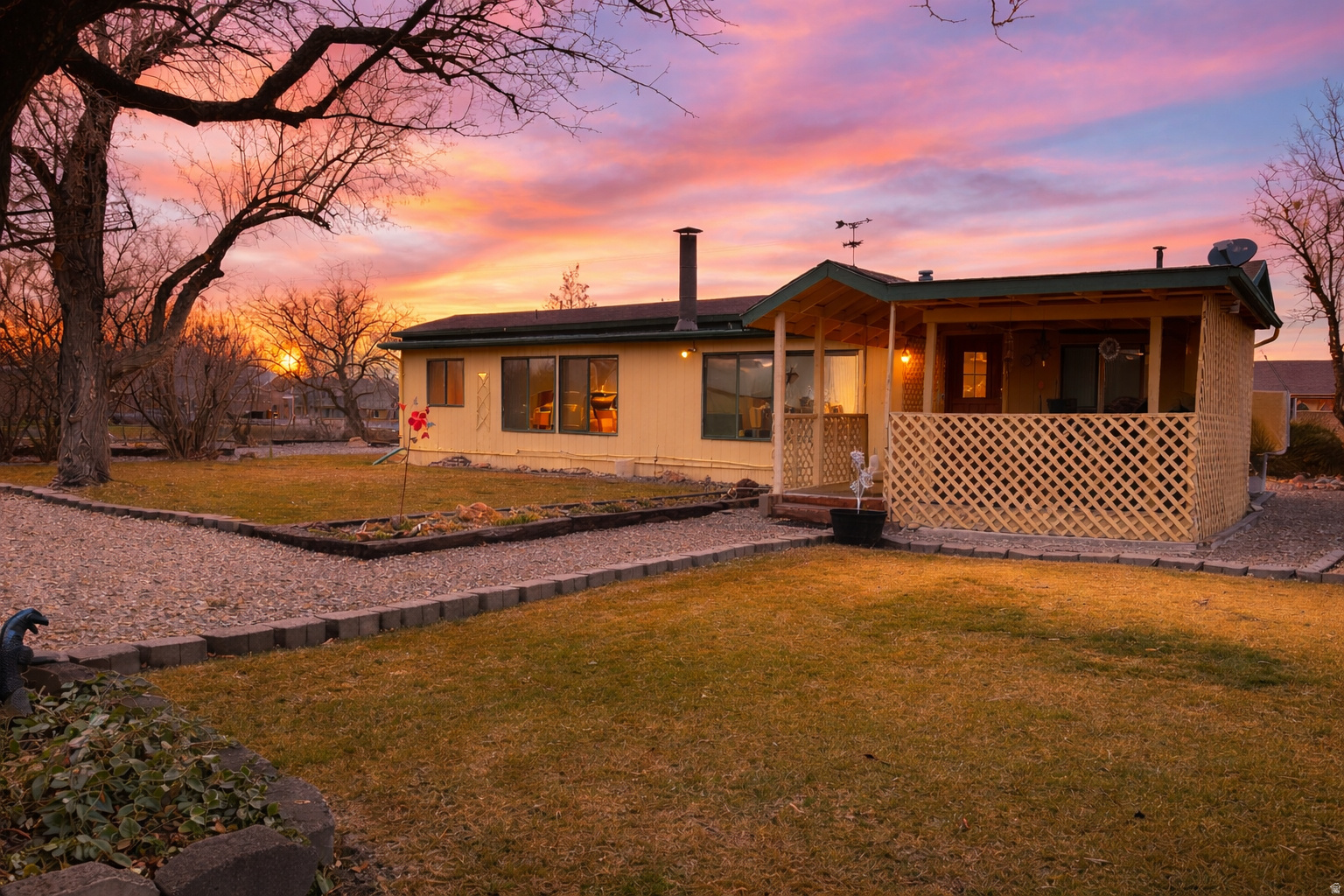Attention HORSE LOVERS, HOBBY FARMERS & HOMESTEADERS...Slow down and enjoy country living on just shy of ONE ACRE (.97). This fully fenced property with Animal Rights features mature landscaping, Two Water shares (alloted thru the city) with potential to SUBDIVIDE and build on the back portion! The 2 bedroom, 2 bath home offers a kitchen with a gas range and plenty of cabinet space, a flex room ideal for an office, workshop or creative studio, a brand new water heater, and a cozy wood burning stove. A wall of south facing windows fills the home with natural light and is perfect for plant lovers & garden starts. Outside, enjoy a covered patio with newer trex decking, a 20x32 workshop with power, a greenhouse, and raised garden beds. In spring and summer, the flower beds are bursting with color and life. Plenty of space for Farm Animals / Livestock, Gardening, RV Parking, and toys. A rare opportunity to spread out, breathe deeper, and enjoy the freedom of country life! Sold "as-is", priced accordingly. All information, including sq ft, is deemed reliable & provided as a courtesy. Buyer/Buyer's agent to verify all to their own satisfaction.