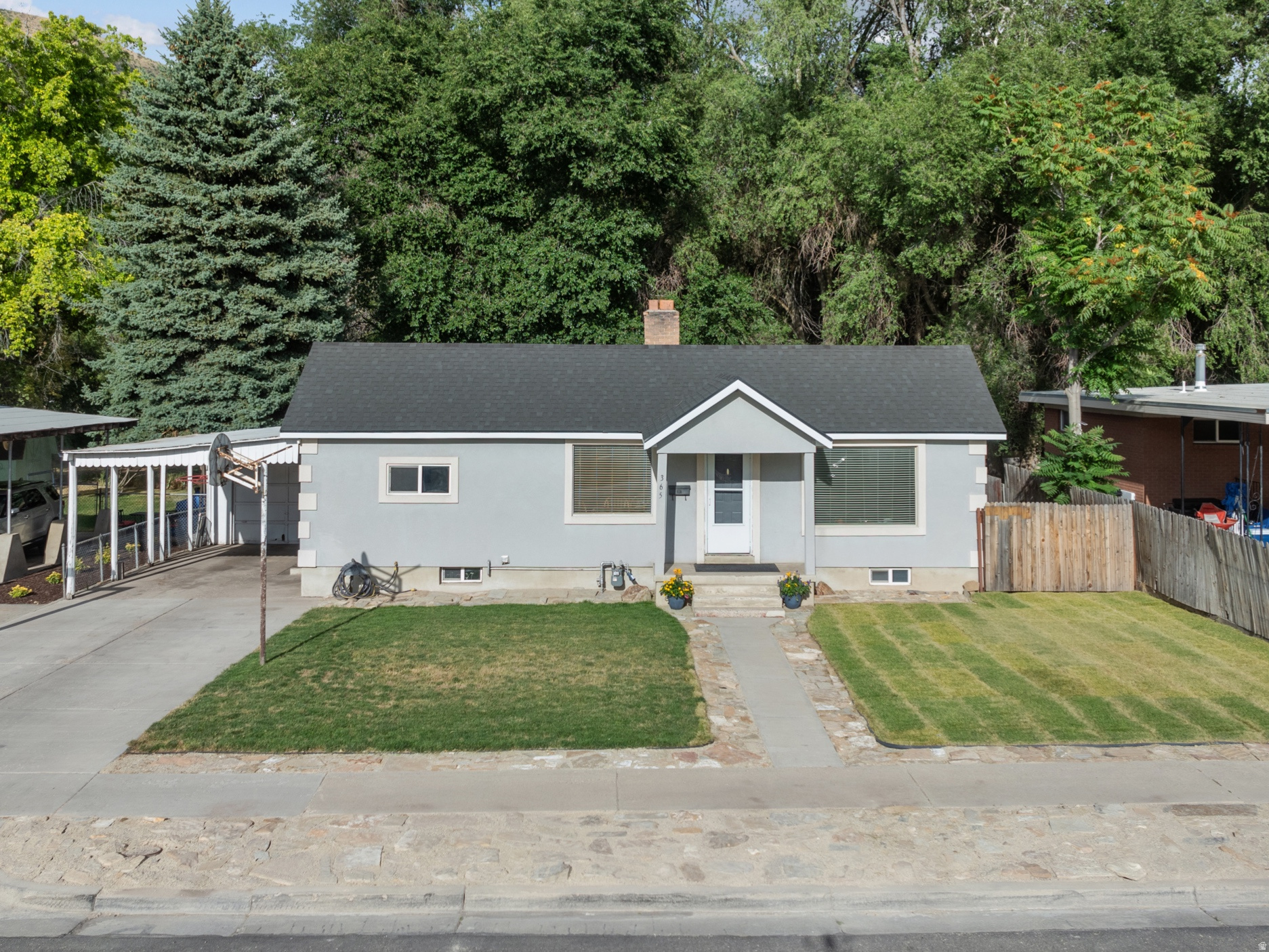 MOVE-IN READY in the heart of Springville! This 4-bedroom home has been completely updated where it counts: newer roof, newer water line, newer sewer line, newer stucco, newer windows, and newer electrical service and panel. The kitchen features newer cabinets, countertops, sink, and dishwasher, with fresh paint and carpet throughout. The basement is roughed in for a second bathroom (contractor bid of $9,500 completed in June 2026), making it ready for your finishing touches. Cozy up by the wood-burning stove or entertain in the fully fenced backyard. The home also includes both a carport and garage, a large laundry room, storage room, and cold storage for all your extras. Additional upgrades include two solar-powered security cameras-one on the front porch and one on the carport-that can both be monitored and managed through a smartphone app, providing added convenience and peace of mind. A new cement driveway and sidewalk complete the curb appeal. Conveniently located near Reams, parks, Hobble Creek Canyon, and with easy access to I-15, this home offers the perfect combination of privacy, convenience, and modern updates. Information provided as a courtesy per seller; buyer is advised to verify all information.   Square footage figures are provided as a courtesy estimate only and were obtained from county records.  Buyer is advised to obtain an independent measurement.