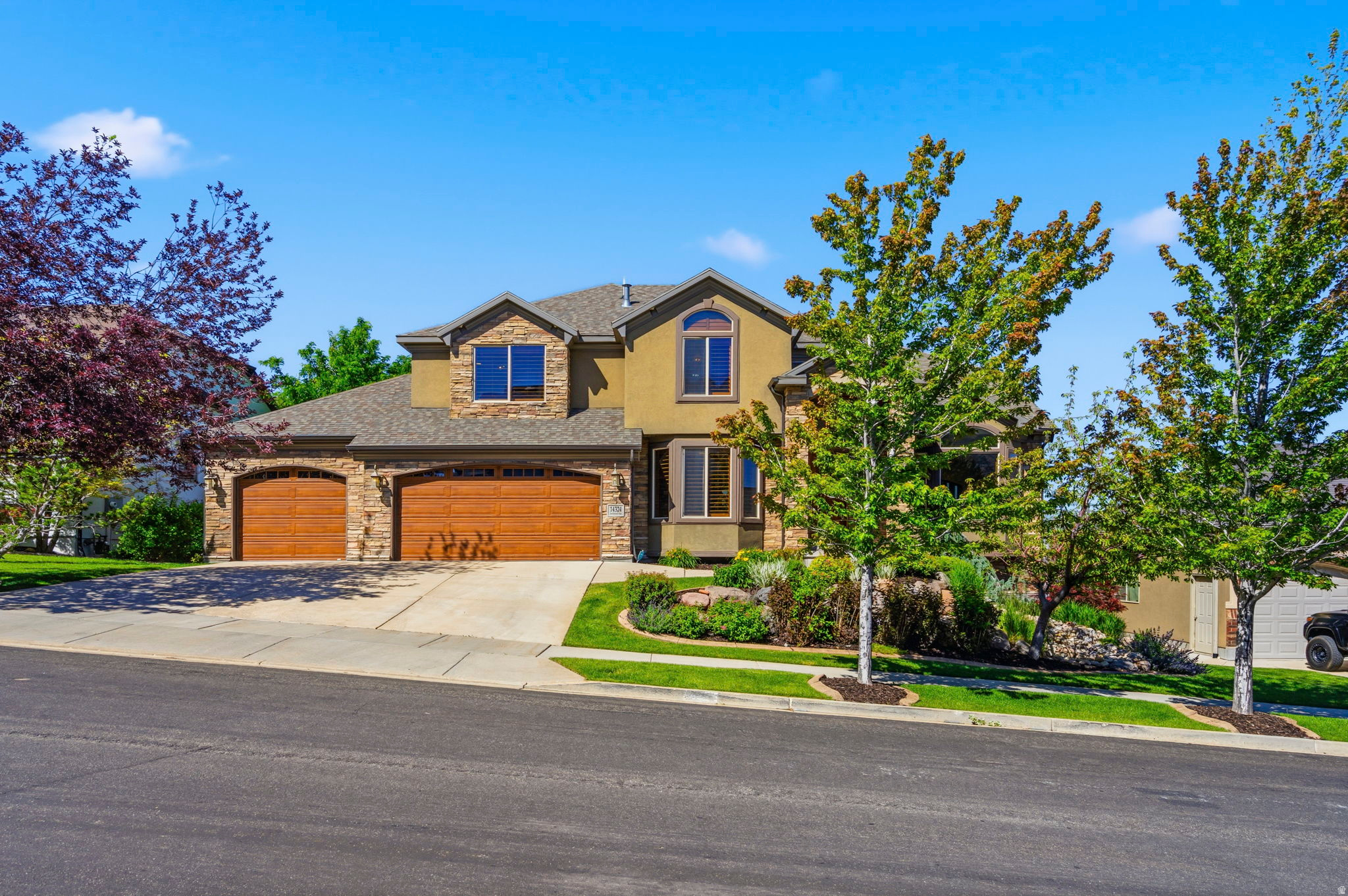 Offered at an incredible price per square foot, and located in one of Draper's most coveted east bench neighborhoods, this home was thoughtfully designed to take advantage of panoramic Salt Lake Valley views, golf course views from the primary suite, and a setting with no rear neighbors. The main level is designed for both everyday living and entertaining, featuring a remodeled kitchen with quartz countertops, a center island, double ovens, and gas stove. The kitchen opens to a spacious family room with custom wood built-ins and a gas fireplace, while a covered composite deck extends the living space outdoors and creates a natural gathering space for dining, entertaining, or simply enjoying the views. A dedicated office with custom built-ins offers a quiet and functional work-from-home space. The dramatic two-story foyer is anchored by an eye-catching Restoration Hardware chandelier, while soaring ceilings, plantation shutters, and expansive windows fill the home with natural light. Upstairs, the primary suite enjoys views of both the Salt Lake Valley and the neighboring golf course and features two walk-in closets with built-in organizers, a jetted tub, and separate shower. Three additional bedrooms, a full bathroom, and a conveniently located laundry room complete the upper level. The fully finished walkout basement provides exceptional flexibility with two additional bedrooms, a full bathroom, kitchenette, dedicated theater room with projector, screen, and built-in speakers, plus extensive storage including cold storage, a separate storage room, and under-stair space. Outside, mature trees, professional landscaping, a fully fenced yard, newly installed sod, and water features in both the front and back yards create a private outdoor setting. The oversized three-car garage includes a Gladiator wall organization system and additional built-in storage that will remain with the home. Additional features include three gas fireplaces, Nest thermostats, a three-zone HVAC system with three furnaces and three air conditioning units, and two 50-gallon water heaters. Located within excellent Draper school boundaries--Oak Hollow Elementary, Draper Park Middle School, and Corner Canyon High School-- and just minutes from hiking and biking trails, golf, parks, shopping, dining, and Silicon Slopes, this home combines thoughtful updates, generous living spaces, and an exceptional location. Square footage figures are provided as a courtesy estimate only and were obtained from county records .  Buyer is advised to obtain an independent measurement.