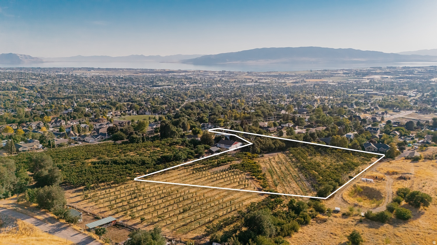 This is a once in a generation opportunity! Positioned on the highly coveted east bench of Pleasant Grove, this 4.5 - acre prime estate lot presents a rare opportunity to own one of Utah Valley's most elite and irreplaceable land parcels. Nestled above the city with commanding, unobstructed views of both Mount Timpanogos & Utah Lake, this wooded, gently sloped lot is the perfect canvas for a luxury custom home or generational estate. Set nearly 300 feet back from the main road, this rectangular building site guarantees serenity, exclusivity, and panoramic beauty. Whether your vision includes a private estate, an architectural showcase home for the Parade Of Homes, or a multi-home family legacy retreat - this property offers the flexibility, privacy, and prestige that are virtually impossible to find in today.