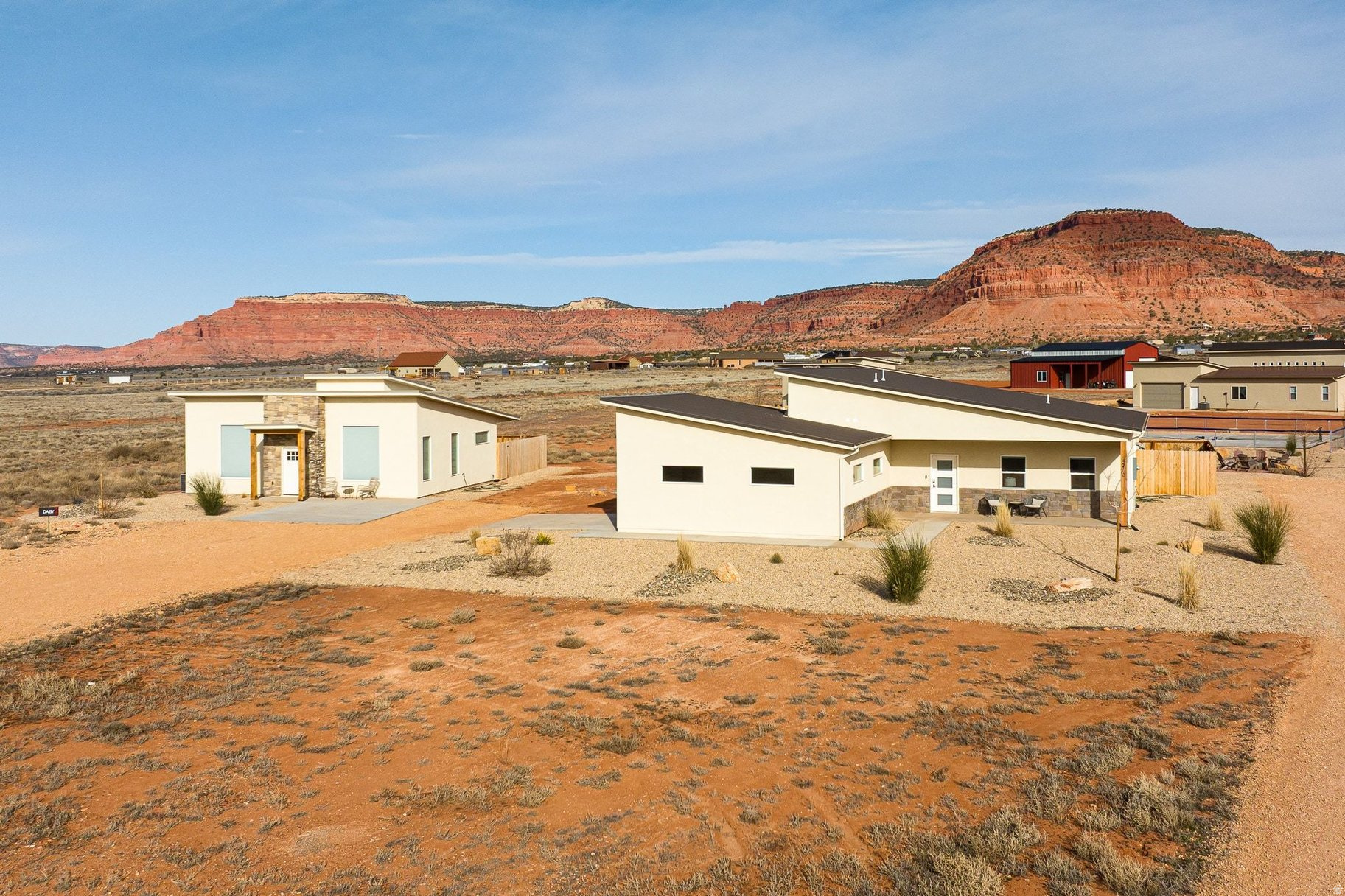 Set against Kanab's striking red rock backdrop, this fully furnished, nightly-rental-approved dual-home retreat sits on 2.29 acres and brings the wow factor with private hot tubs at both the main house and the casita-a rare and irresistible upgrade for guests and owners alike. Designed for comfort, connection, and income potential, this property offers a flexible two-residence setup that feels like a boutique desert resort.  The main home spans 1,813 sq ft with an attached 2-car garage and a bright, open great room perfect for hosting. Vaulted ceilings, oversized windows, wide-plank flooring, and a modern kitchen create a light-filled space that flows effortlessly to outdoor living-where evenings are best spent soaking under Southern Utah's starry skies.  The detached casita offers 1,232 sq ft including a 136 sq ft loft, providing a private and equally well-appointed stay for guests or extended family. Both residences come fully furnished with all appliances and dcor included, making this a true turnkey property-ready to operate as a nightly rental from day one.  Beyond the homes themselves, owners and guests enjoy access to resort-style amenities including a large outdoor swimming pool, fire pit lounge area, pickleball courts, and a swing set for kids-enhancing the experience for families, groups, and adventure travelers. Located near Lake Powell, Zion National Park's East Entrance,numerous other parks and travel destinations,endless hiking and biking trails, and just minutes from Kanab's dining and art scene, this property offers a rare blend of relaxation, recreation, and revenue potential.  Whether you're curating a high-end short-term rental experience or building a private desert retreat with room to host in style, this turnkey, two-home property delivers space, amenities, and unforgettable Southern Utah atmosphere.