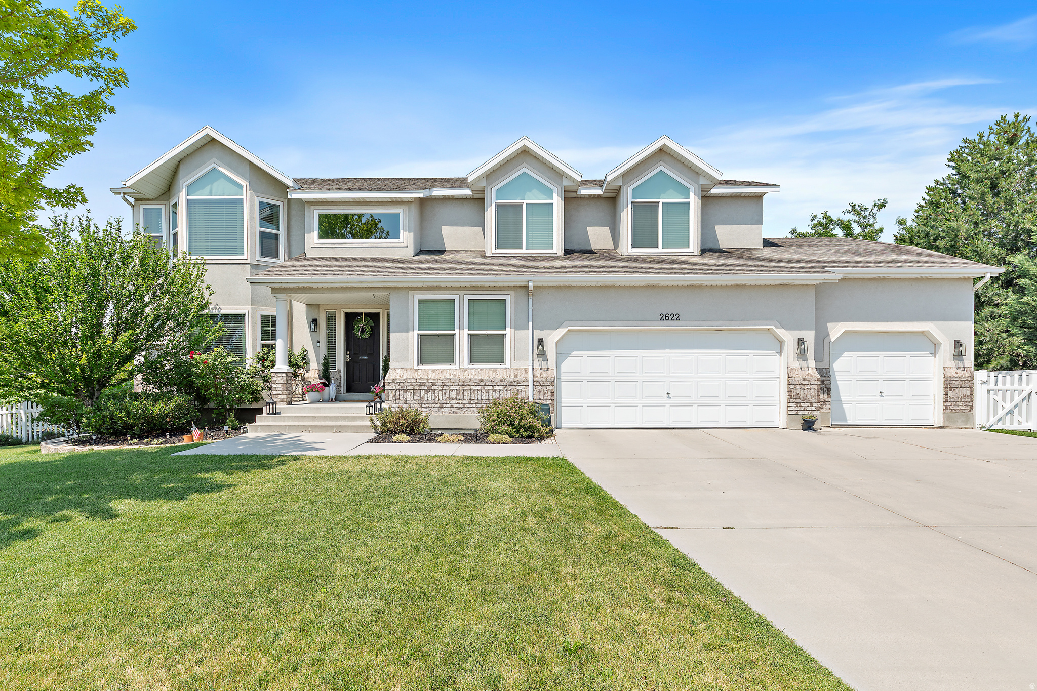 Welcome home to this beautifully maintained 7 bedroom gem nestled in a great location. From the moment you walk in, you're greeted with natural light and a layout that just feels right. The kitchen shines with new quartz countertops and a fresh backsplash, and the updates don't stop there the sellers have put in custom built-ins in the living room next to the new fireplace insert, new windows, a new roof (2025), and a tankless water heater. Downstairs, the finished basement features an in home theater room for those movie nights everyone loves, (projector is included) plus tons of storage throughout the home. Step outside to the new covered composite deck perfect for entertaining, and park with ease in the 3 car garage that has newly epoxied floors. The home is located within walking distance to the elementary and high school nearby, and with easy access to I-15 commuting north or south is a breeze. Everything you need is within mins of the home.  Square footage figures are provided as a courtesy estimate only. Buyer is advised to obtain an independent measurement.