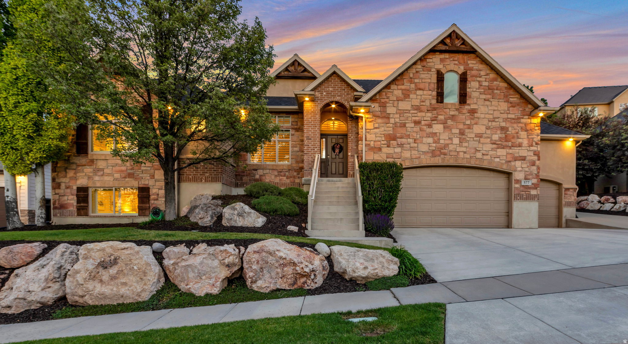 Luxury mountain living in North Salt Lake with stunning Wasatch views from the main living areas and primary suite, just minutes from Eaglewood Golf Course. This extensively updated home features significant improvements completed between 2021 and 2025, including a fully remodeled designer kitchen with Dal-tile quartz waterfall countertops, full-height quartz backsplash, refinished soft-close cabinetry, Kohler fixtures, and custom pendant lighting. The renovated owner's suite features Schluter heated floors, marble floors in shower, Grohe dual rain shower heads with body sprayers, a standalone soaking tub, seamless glass enclosure, custom dual vanities with backlit LED mirrors, and a custom his-and-hers walk-in closet. Both guest bathrooms have been fully remodeled with quartz and marble countertops, glass tile and subway tile showers, and updated fixtures throughout. Additional upgrades include a 30-year Owens Corning architectural roof, dedicated home gym addition, Lutron Caseta smart lighting, Google Fiber infrastructure, Aqara biometric smart locks, Rachio smart irrigation, outdoor architectural speakers, refreshed landscaping, and new hardware, fixtures, and ceiling fans throughout.