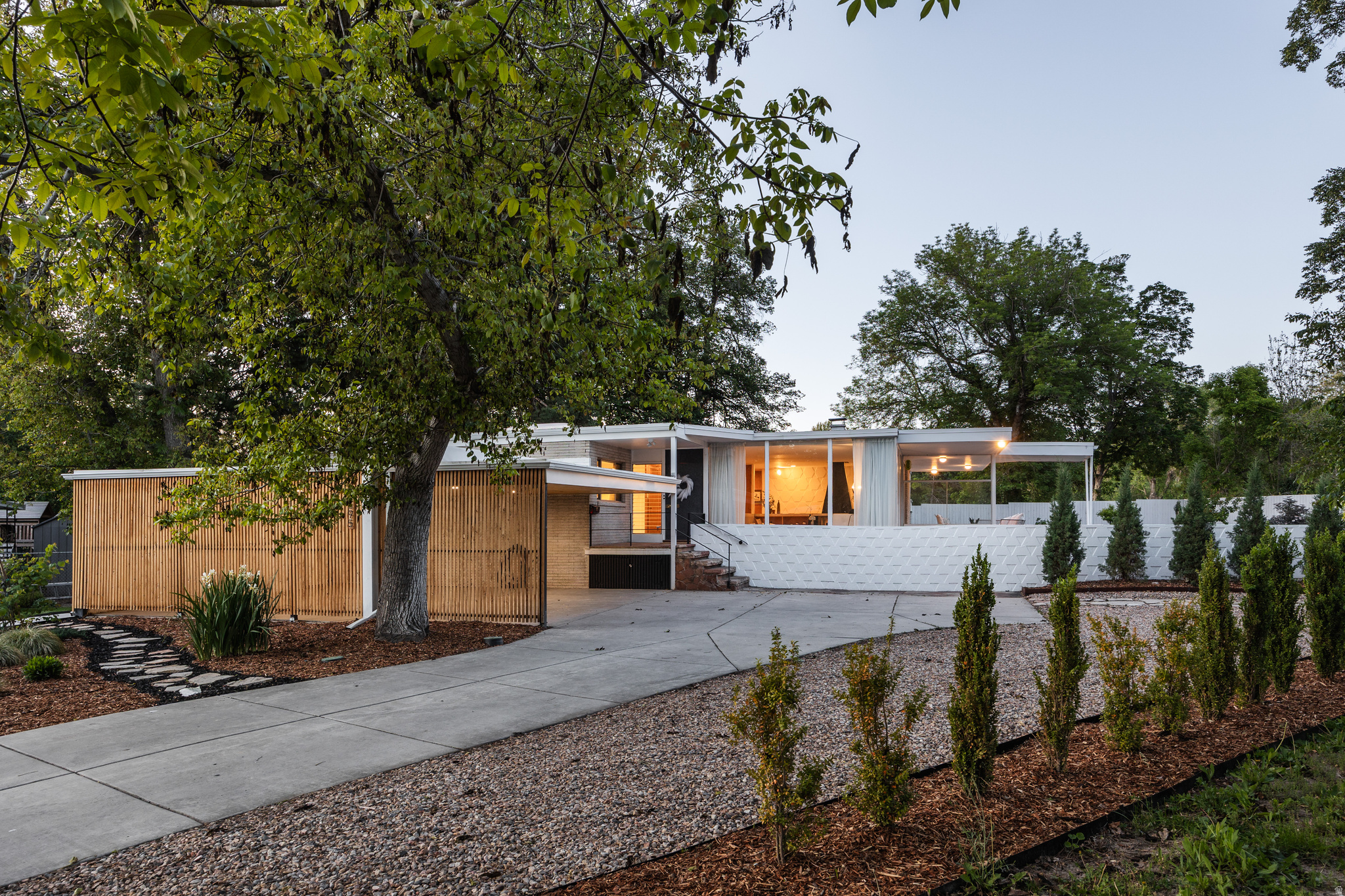 MULTIPLE OFFERS RECEIVED, OFFERS DUE BY TUESDAY AT 5PM. Ed Dreier homes are iconic pieces of mid-century architecture, and as such, we love to see them respected. This is another masterwork of his Salt Lake City portfolio, and it's been thoughtfully restored and lovingly maintained. Original details are intact throughout, and while modern updates have been made, it's only where they genuinely improve the living experience. Set privately at the end of a cul-de-sac with no rear neighbors, the home is canopied by mature trees on a generous lot. As you might expect, the home does exactly what the architect intended in connecting the interior and exterior seamlessly: floor-to-ceiling glass walls draw in both light and landscape in equal measure. Original wood paneling, concrete block walls, a stunning period fireplace with terrazzo mantle, and a stone entry remain fully intact, thanks to responsible ownership and a genuine appreciation for the architecture. The kitchen has been updated to meet modern needs without losing the home's sensibility-clean lines and minimal design lend themselves to convenience and easy gathering. Main floor living keeps daily life easy, and downstairs, you'll find two additional rooms that offer flexibility, whether it be for a wine cellar, studio, or private office. The lower-level bathroom is plumbed with gas and water for a future sauna. Situated between Sugar House and Holladay, this one has the privacy of a secluded setting and the convenience of both neighborhoods close at hand. Homes of this architectural significance, and restored to this standard, are genuinely rare-don't hesitate on this one. Square footage figures are provided as a courtesy estimate only. Buyer to verify all.