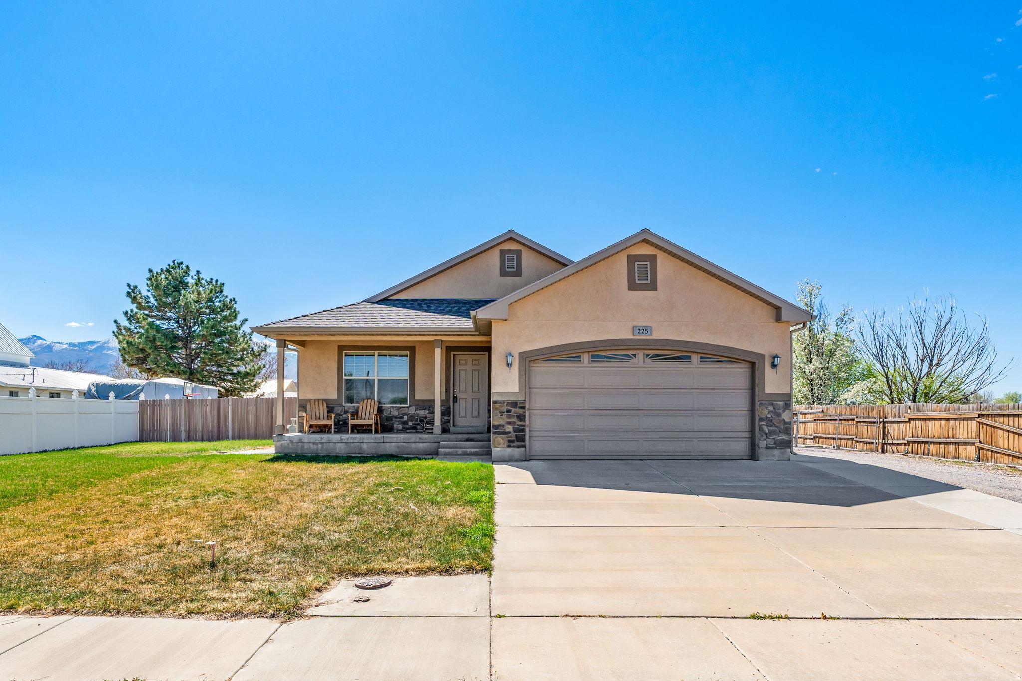 This great home has main level living with room to grow with it's full basement, mostly finished. Main level has formal living room, family room combined with kitchen, 3 bedroom/2 bathrooms and the laundry room. Basement has another bedroom, storage areas, living room- ready to finish to your needs. Basement is also plumbed for bathroom. Gun safe is included.  Large, covered RV parking and separate ATV garage/workshop in back yard. Home has a large patio, a fully fenced yard and fixed lighting in the eves. Includes 1/4 share of Fillmore Water Users irrigation water and large swing set.