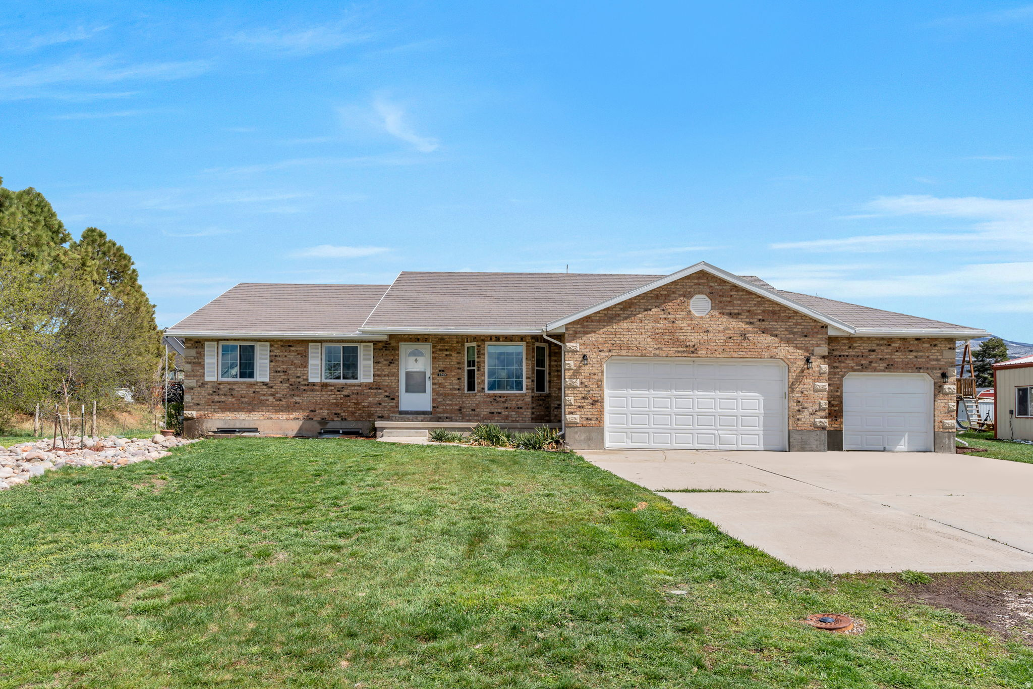 Set against the breathtaking backdrop of Heber Valley's open skies and mountain views, this extraordinary one+ acre property offers a rare blend of immediate livability and long-term vision. Anchored by a solid 3,768 sq ft brick home and a versatile shop, the property provides both comfort today and opportunity for tomorrow. The home offers generous square footage and timeless construction, making it ideal as a primary residence, rental, or base of operations while future plans take shape. The on-site shop adds exceptional value-perfect for storage, hobbies, business use, or expansion potential. What truly sets this property apart is its flexibility and scale. With ample acreage in one of Wasatch County's most sought-after areas. Located just minutes from world-class recreation, including Deer Valley Resort, Jordanelle Reservoir, trails, golf, and the charm of downtown Heber City, this property captures the valley's unique balance of rural serenity and modern convenience. Whether your vision is to enjoy the existing home, expand, redevelop, or create something entirely new, this is a once-in-a-generation opportunity to own a versatile property in the heart of Heber Valley-where land, lifestyle, and potential converge.