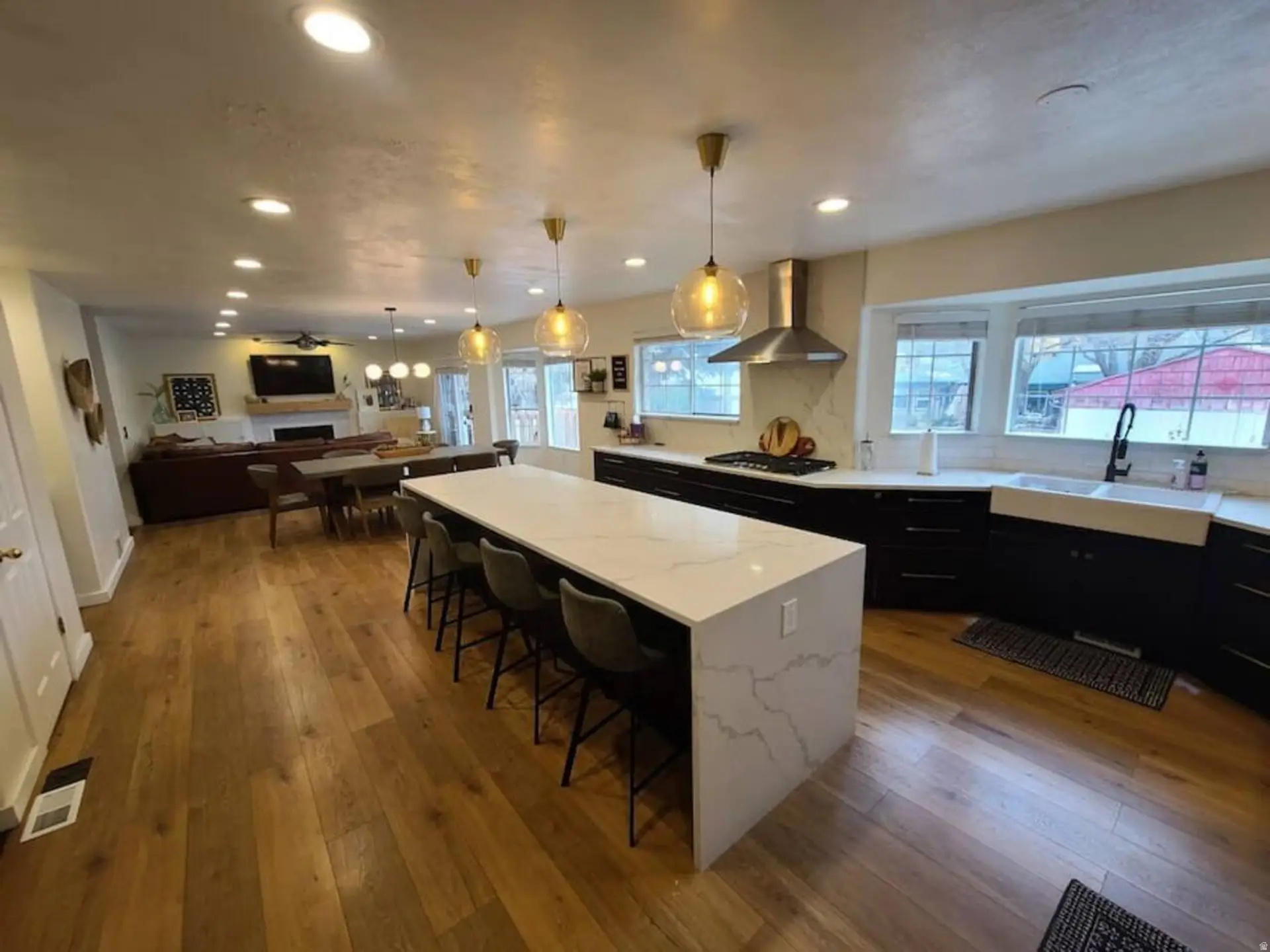 Beautiful Cottonwood Heights home featuring a fully finished 3 bed  2 bath mother-in-law basement with excellent potential for 30+ day rentals, offering a great opportunity for additional income in ski season. The backyard is built for entertaining and relaxation with a large swim spa and private pickleball court. A unique bonus is the city-maintained half-acre grass area directly next to the property that can be enjoyed 24/7 without the upkeep-the city handles mowing and maintenance. Rare combination of space, recreation, and income potential in a highly desirable location.