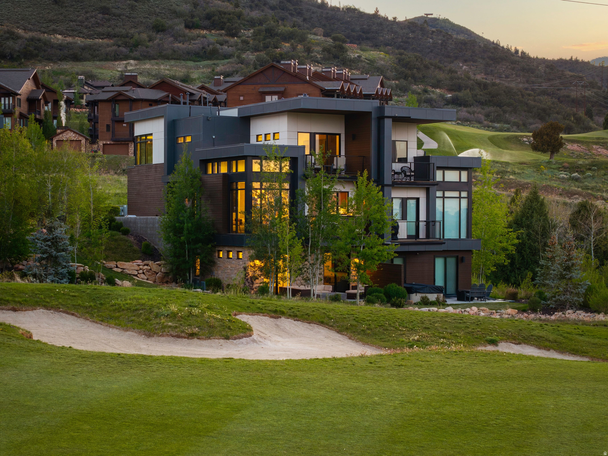 Nestled in Canyons Village, this beautifully maintained Viridian townhome offers bright, modern mountain living with seamless indoor-outdoor connection at every turn. Thoughtfully designed for family and friends, the home features elevated finishes, expansive gathering spaces, and outdoor living access on every floor, creating an effortless flow for entertaining and everyday living. The spacious great room is centered around a striking steel and wood fireplace and opens to a deck overlooking the golf course with views of Iron Mountain, Unita Mtns, and Bald Mountain. The chef's kitchen is appointed with premium Wolf and Sub-Zero appliances, a custom breakfast nook with built-in banquette seating, and thoughtful upgrades throughout, including stylish wallpaper and designer touches. Multiple living spaces, including two family rooms, provide flexibility for hosting family and guests, while five bedrooms and six bathrooms offer comfort and privacy for all. The primary suite serves as a private retreat with a spa-inspired bathroom, walk-in closet, and private deck showcasing stunning views. Sold fully furnished and offering true lock-and-leave ownership, this home also features three decks, abundant storage, two laundry areas, and an attached two-car garage. Enjoy fantastic views of the Canyons Village Golf Course and Iron Mountain, nightly rental eligibility, and effortless access to skiing just moments away - either take a short walk to the lift or summon Canyon Connect directly to your door for seamless mountain or restaurant access. Residents also enjoy community amenities including a heated pool and hot tub.