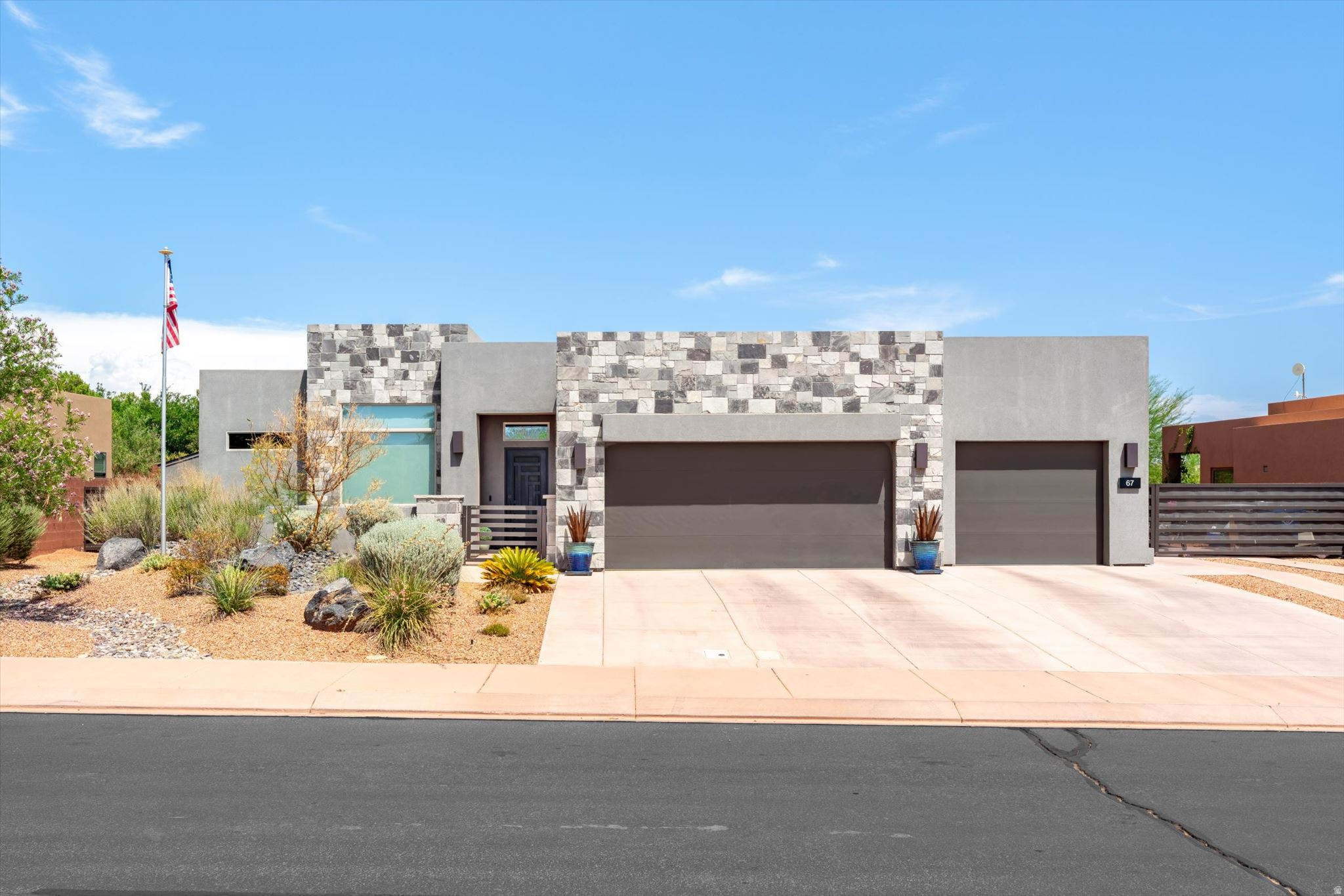 Modern luxury meets effortless living in this exceptional custom home in the highly sought-after Silver Sage community of Ivins. Thoughtfully designed with soaring ceilings, wide-plank tile flooring, designer lighting, and expansive windows, this single-level home is filled with natural light and showcases quality craftsmanship throughout. The open-concept great room is anchored by a stunning floor-to-ceiling stone fireplace with custom built-ins and flows seamlessly into the chef's kitchen featuring quartz countertops, custom cabinetry, premium stainless steel appliances, gas cooktop, double wall ovens, walk-in pantry, oversized island, and abundant prep space. The dining area overlooks the beautifully landscaped backyard, creating the perfect setting for everyday living. The spacious primary suite is a true retreat with a spa-inspired bath featuring dual vanities, a freestanding soaking tub, oversized walk-in tile shower with dual showerheads and bench seating, and an impressive custom walk-in closet with extensive built-ins. Three additional bedrooms provide flexible space for guests, hobbies, or home offices, while beautifully appointed bathrooms feature quartz countertops and designer finishes. Additional highlights include a dedicated office, oversized laundry room with sink, extensive cabinetry and workspace, plus a custom mudroom for added convenience. Step outside to an oversized covered patio designed for year-round enjoyment, overlooking a lush lawn, mature landscaping, and peaceful desert surroundings. The spacious backyard offers room for a future pool while RV parking, a storage shed, and an oversized 3-car garage provide exceptional storage and functionality. Located just minutes from Snow Canyon State Park, Black Desert Resort, Tuacahn Center for the Arts, championship golf, hiking, biking, and endless outdoor recreation, this remarkable home combines luxury, comfort, and the unmatched beauty of Southern Utah into one extraordinary opportunity.