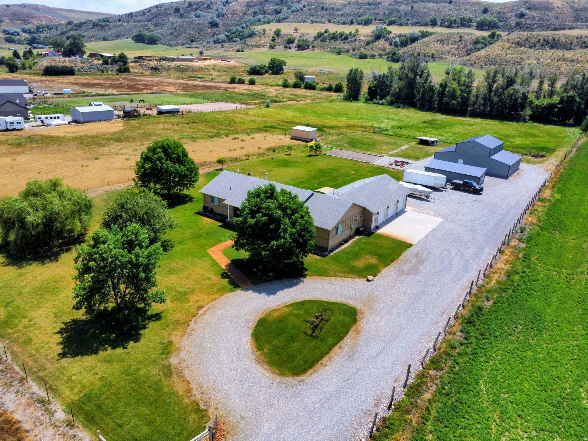 Experience the perfect blend of country living and modern comfort with this beautifully updated single-level home situated on 11.24 acres in the highly sought-after Riverdale area of Preston, Idaho. Offering. 4 bedrooms, 3 bathrooms, and an open, functional floor plan, this immaculate property is move-in ready and designed for both everyday living and entertaining.  Inside, you'll find a spacious, light-filled interior featuring numerous updates, and tasteful finishes throughout. The open-concept layout seamlessly connects the kitchen, dining, and living areas, creating an inviting space for family gatherings and entertaining guests.  Step outside to enjoy the beautifully landscaped yard with mature trees, lush green space, and plenty of room to relax while taking in the peaceful country setting. The property includes 4 valuable water shares, making it ideal for irrigating pasture or supporting livestock.  A standout feature is the large shop with an attached space already framed for an Accessory Dwelling Unit (ADU), with a seperate septic system, offering incredible potential for guest quarters, rental income, multigenerational living, or a home office. An additional detached building currently serves as a private gym, providing even more flexibility for hobbies, fitness, or workspace.  Additional amenities include a 3-car attached garage, ample parking for RVs and equipment, and expansive acreage perfectly suited for horses, livestock, or anyone seeking room to roam. Conveniently located just minutes from Downtown Preston and close to Riverdale Resort  Whether you're looking for a hobby farm, equestrian property, or simply a beautifully maintained home with acreage, this exceptional property offers endless possibilities. Schedule your private showing today and discover everything this one-of-a-kind property has to offer.
