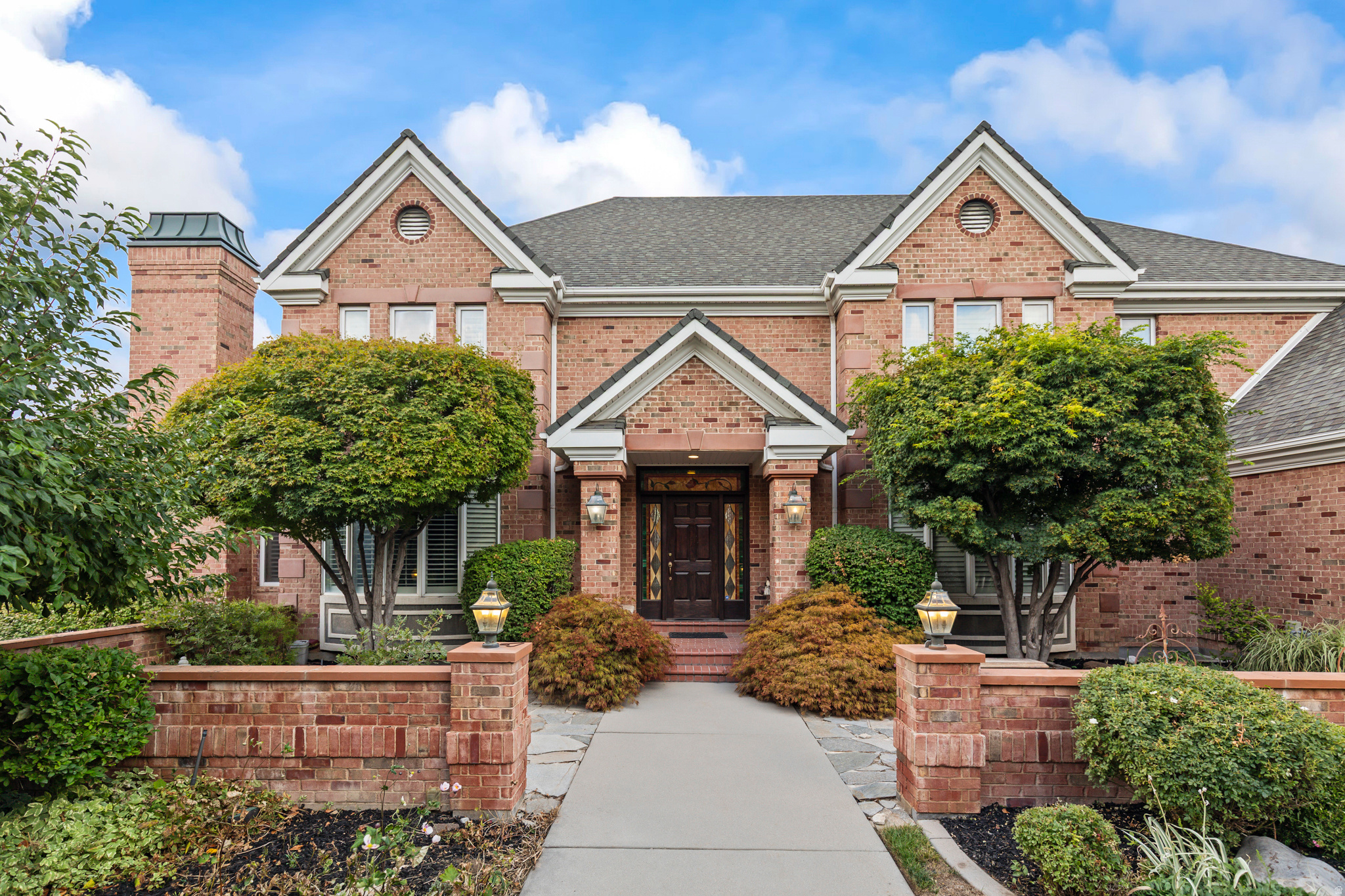 An extraordinary estate tucked into one of the area's most picturesque natural settings! Secluded custom brick home nestled in a cul de sac against a mountainside setting with mature trees, a seasonal creek, and beautifully manicured landscaping with over 400 trees and shrubs. This timeless home showcases exceptional craftsmanship and custom finish work throughout, including extensive crown molding, detailed base and case trim, and quality finishes that elevate every space. Designed for both luxurious living and entertaining, the home offers spacious gathering areas, while the basement features two walkout entrances plus an impressive recreation and gym area built beneath the three-car garage with soaring 15-foot ceilings. Property also includes an incredible oversized 3,000 sq foot RV garage and shop with 14-foot garage doors, along with a basement level and 3/4 bathroom - ideal for hobbies, storage, projects, or additional workspace. Enjoy resort-style outdoor living with a heated swimming pool featuring an electric cover and auto chlorinator for convenience and easy maintenance. A rare opportunity to own a luxury retreat with breathtaking natural surroundings, remarkable amenities, and unforgettable presence.