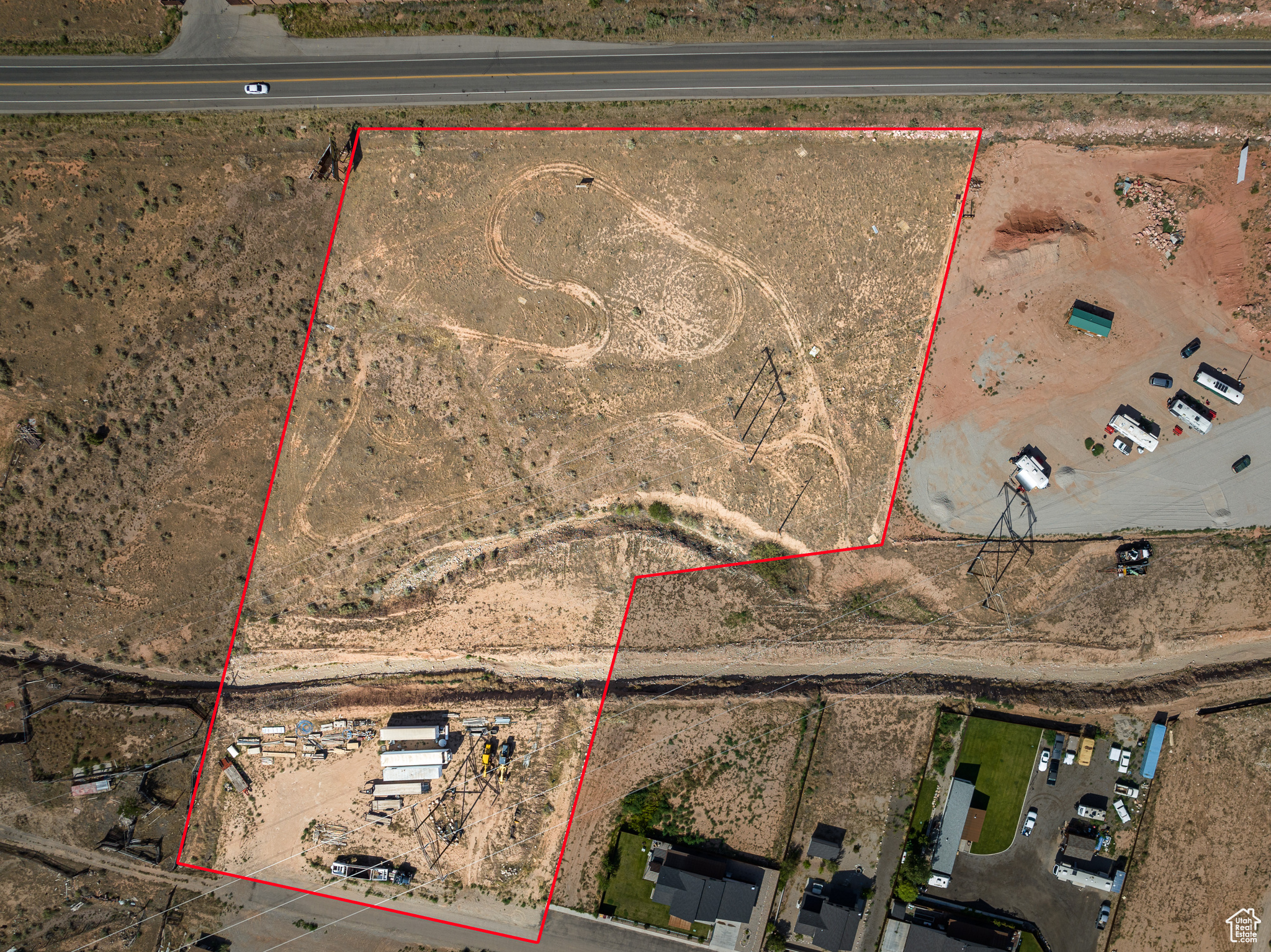OPPORTUNITY ABOUNDS  with Canyon Shadow Subdivision! Located in San Juan County, this 4.67-acre development parcel offers over 440 ft of Highway 191 frontage. A rare gem in Moab's investment market, Canyon Shadow Subdivision presents exceptional short-rental potential  either with a permitted hotel or motel or with the current platted 16unit twin home subdivision with approved short-term rental use. The current common area provides ample space for additional trailer parking and other non-structural amenities, enhancing the versatility of the site. It's your opportunity to build with the current subdivision or liquidate the current plat to make it a clean palate for your personal vision! Situated in close proximity to Ken's Lake, Steel Bender Trail, Behind the Rocks, and the La Sal Mountains, Canyon Shadow offers a prime location for outdoor enthusiasts and investors alike.