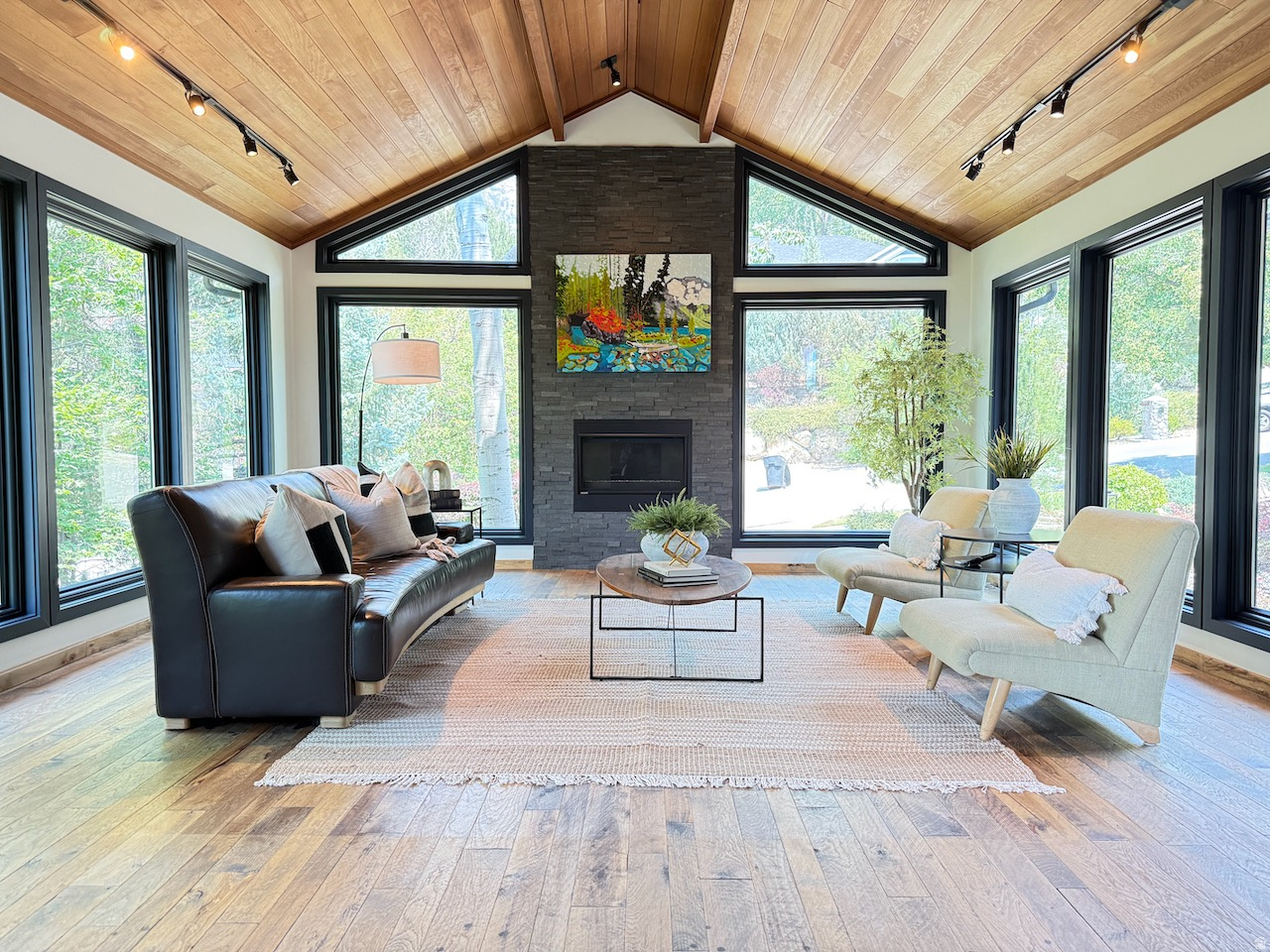 COMING SOON, Showings to begin June 26th. Perched above Wasatch Blvd in the coveted CANYON COVE subdivision, 6458 Canyon Cove Drive offers commanding mountain and city-light views in one of the most desirable neighborhoods in Holladay. Listed at $1,399,999, this 5-bedroom, 4-bath residence spans 4,654 square feet. Offering the perfect blend of mountain serenity and sophisticated living. Ideally located near top-rated schools, shopping, parks, Old Mill Golf Course, and Heughs Canyon Trailhead, with downtown Salt Lake City just 15 minutes away and world-class skiing in Big and Little Cottonwood Canyons only minutes from your door. Step inside to soaring vaulted ceilings, a striking floor-to-ceiling stone fireplace, and expansive windows that frame breathtaking mountain vistas and twinkling city lights. Meticulously maintained and thoughtfully updated, this exceptional home offers a new roof, upgraded electrical panel with EV charger, new garage and interior doors, fresh interior and exterior paint, and rich Hickory hardwood and slate flooring, creating a refined blend of comfort and elegance. Designed for ultimate comfort and entertaining, the open-concept floor plan seamlessly integrates the kitchen, dining, and living areas. Large gathering areas flow seamlessly onto an updated main-level deck featuring new Trex decking and sleek railings designed to maximize the views. An ideal backdrop for alfresco dining, entertaining guests, or simply unwinding to witness unforgettable sunsets and twinkling city lights.  The luxurious primary suite offers a private fireplace, Trex viewing deck, stunning mountain and city views, and a spacious en-suite bath. Two additional bedrooms and a full bathroom on the same level create a functional and private bedroom wing. The first lower level includes an oversized 3-car garage with 220-volt power, workbench area, additional storage, laundry room, 3/4 bathroom, and a fourth bedroom ideal for guests or extended family. The walkout lower level is perfectly suited for multi-generational living, featuring a large family room with wet bar, dedicated home office, fifth bedroom, and 3/4 bathroom. Direct backyard access extends the living space outdoors to a fully fenced yard with plenty of room for recreation and entertaining. This remarkable property presents a rare opportunity to own a piece of Holladay's finest living. All information herein is deemed reliable but is not guaranteed. Buyer is responsible for verifying all listing information, including square feet/acreage, to the buyer's own satisfaction.