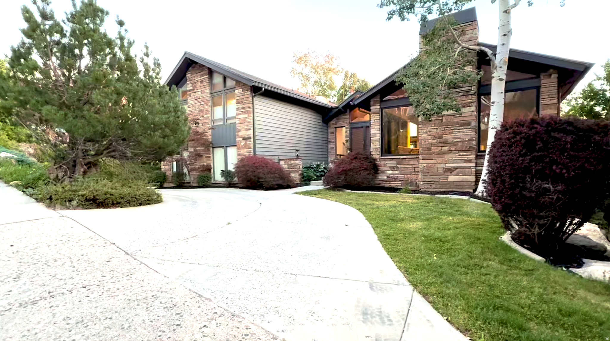 COMING SOON, Showings to begin June 26th. Perched above Wasatch Blvd in the coveted CANYON COVE subdivision, 6458 Canyon Cove Drive offers commanding mountain and city-light views in one of the most desirable neighborhoods in Holladay. Listed at $1,399,999, this 5-bedroom, 4-bath residence spans 4,654 square feet. Offering the perfect blend of mountain serenity and sophisticated living. Ideally located near top-rated schools, shopping, parks, Old Mill Golf Course, and Heughs Canyon Trailhead, with downtown Salt Lake City just 15 minutes away and world-class skiing in Big and Little Cottonwood Canyons only minutes from your door. Step inside to soaring vaulted ceilings, a striking floor-to-ceiling stone fireplace, and expansive windows that frame breathtaking mountain vistas and twinkling city lights. Meticulously maintained and thoughtfully updated, this exceptional home offers a new roof, upgraded electrical panel with EV charger, new garage and interior doors, fresh interior and exterior paint, and rich Hickory hardwood and slate flooring, creating a refined blend of comfort and elegance. Designed for ultimate comfort and entertaining, the open-concept floor plan seamlessly integrates the kitchen, dining, and living areas. Large gathering areas flow seamlessly onto an updated main-level deck featuring new Trex decking and sleek railings designed to maximize the views. An ideal backdrop for alfresco dining, entertaining guests, or simply unwinding to witness unforgettable sunsets and twinkling city lights.  The luxurious primary suite offers a private fireplace, Trex viewing deck, stunning mountain and city views, and a spacious en-suite bath. Two additional bedrooms and a full bathroom on the same level create a functional and private bedroom wing. The first lower level includes an oversized 3-car garage with 220-volt power, workbench area, additional storage, laundry room, 3/4 bathroom, and a fourth bedroom ideal for guests or extended family. The walkout lower level is perfectly suited for multi-generational living, featuring a large family room with wet bar, dedicated home office, fifth bedroom, and 3/4 bathroom. Direct backyard access extends the living space outdoors to a fully fenced yard with plenty of room for recreation and entertaining. This remarkable property presents a rare opportunity to own a piece of Holladay's finest living. All information herein is deemed reliable but is not guaranteed. Buyer is responsible for verifying all listing information, including square feet/acreage, to the buyer's own satisfaction.