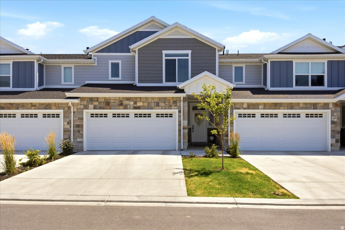Showings Start Friday July 17th!  Picture Perfect in this like new townhome featuring handsome exterior of board-n-batten, stone & stucco and lush landscaping. Main floor has thoughtfully designed floorplan having an open concept great room with easy-maintenance LVP wood-look flooring, large windows throughout for lots of natural light, generous kitchen with center island having ample storage plus large walk-in pantry, roomy dining area with sliding glass door to patio, and half bath. Upstairs features a spacious primary bedroom with en suite and walk-in closet, 2 additional bedrooms and 1 full bath, laundry room, 3-panel doors and oil-rubbed bronze hardware. Attached 2-car garage. This smaller, desirable townhome community is tucked back from main street and right next to Canterbury Park plus conveniently located near shopping, restaurants and entertainment and quick access to the West Davis Corridor!  Schedule via Aligned Showings.
