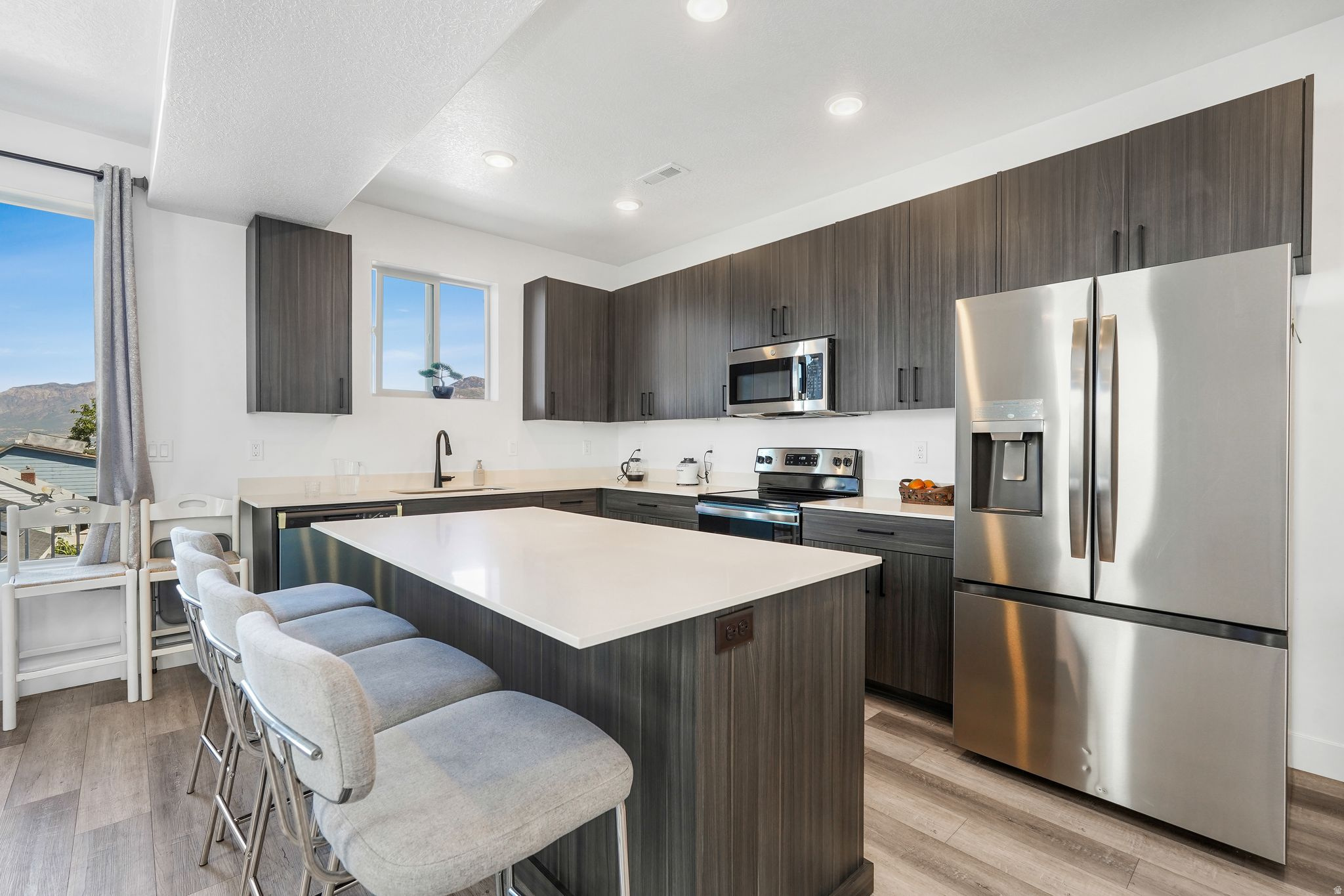 Welcome to this stunning end-unit townhome completed in 2024. Offering 3 bedrooms and 2.5 baths across a modern living space. Flooded with natural light, the open floor plan is perfectly designed to showcase those breathtaking mountain views. Just minutes away from Newgate Mall, Riverdale Shopping Center, and South Ogden Nature Park, you'll have endless options for shopping, dining, and recreation right at your fingertips. Love the outdoors? Hiking, biking, skiing, and kayaking are all nearby plus Snowbasin Resort is only a short drive away. Convenient commuter access via U-S-89 and I-15 making travel a breeze. Stylish, location-forward, and move-in ready-this home is waiting for you.