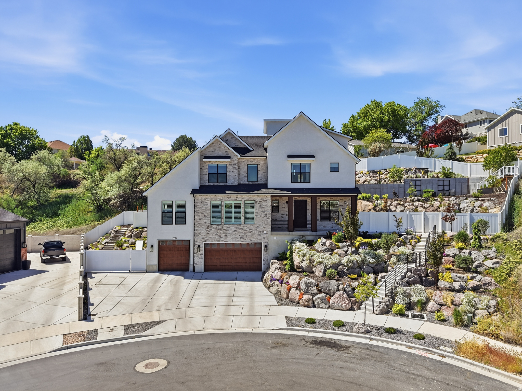 Elevated South Jordan luxury with panoramic mountain and valley views. This stunning two-story home blends refined design with premium finishes throughout-including a private elevator, stone and stucco exterior, and an oversized three-car garage.  The open-concept interior features plantation shutters, recessed lighting, and premium LVP flooring. The chef's kitchen impresses with a quartz island, white shaker cabinetry with brass hardware, professional-grade range with pot filler, and top-tier stainless appliances.  The primary suite offers a serene retreat with tray ceiling and large view windows. A rooftop deck with hot tub, turf, and string lighting delivers breathtaking views, while the terraced backyard with natural rock, patios, and mature landscaping completes this exceptional property.  24 hr notice prior to showing.  Square footage figures are provided as a courtesy estimate only and were obtained from County records .  Buyer is advised to obtain an independent measurement.