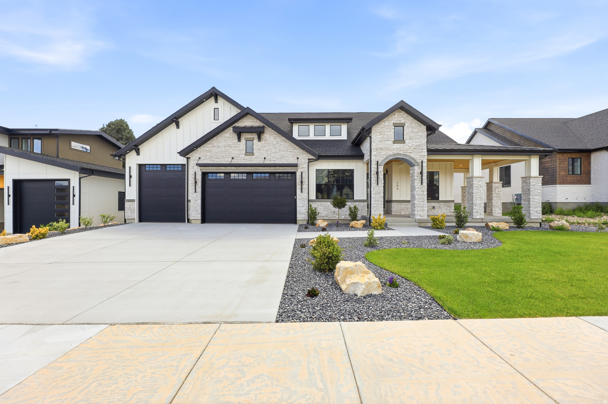 This beautifully designed home offers 5 bedrooms and 5 bathrooms with an open-concept layout perfect for both everyday living and entertaining. The spacious kitchen is a true centerpiece, featuring a double oven, a 6-burner stove with a sleek hood, and plenty of room to gather. The primary bedroom is a true retreat, boasting a generously sized layout, a spa-like bathroom with a standalone soaking tub, and a massive custom-built closet. Downstairs, the basement bedrooms each include their own ensuite bathrooms, providing comfort and privacy for guests or family, along with a fully equipped home theater and a stylish wet bar complete with a beverage fridge-ideal for hosting or relaxing. The impressive garage setup includes 10-foot and 12-foot doors with soaring 16-foot ceilings, insulated doors, and a fully finished interior for added functionality. Outside, a covered patio provides the perfect space to unwind, while built-in cement planters are ready for your personal landscaping touch.