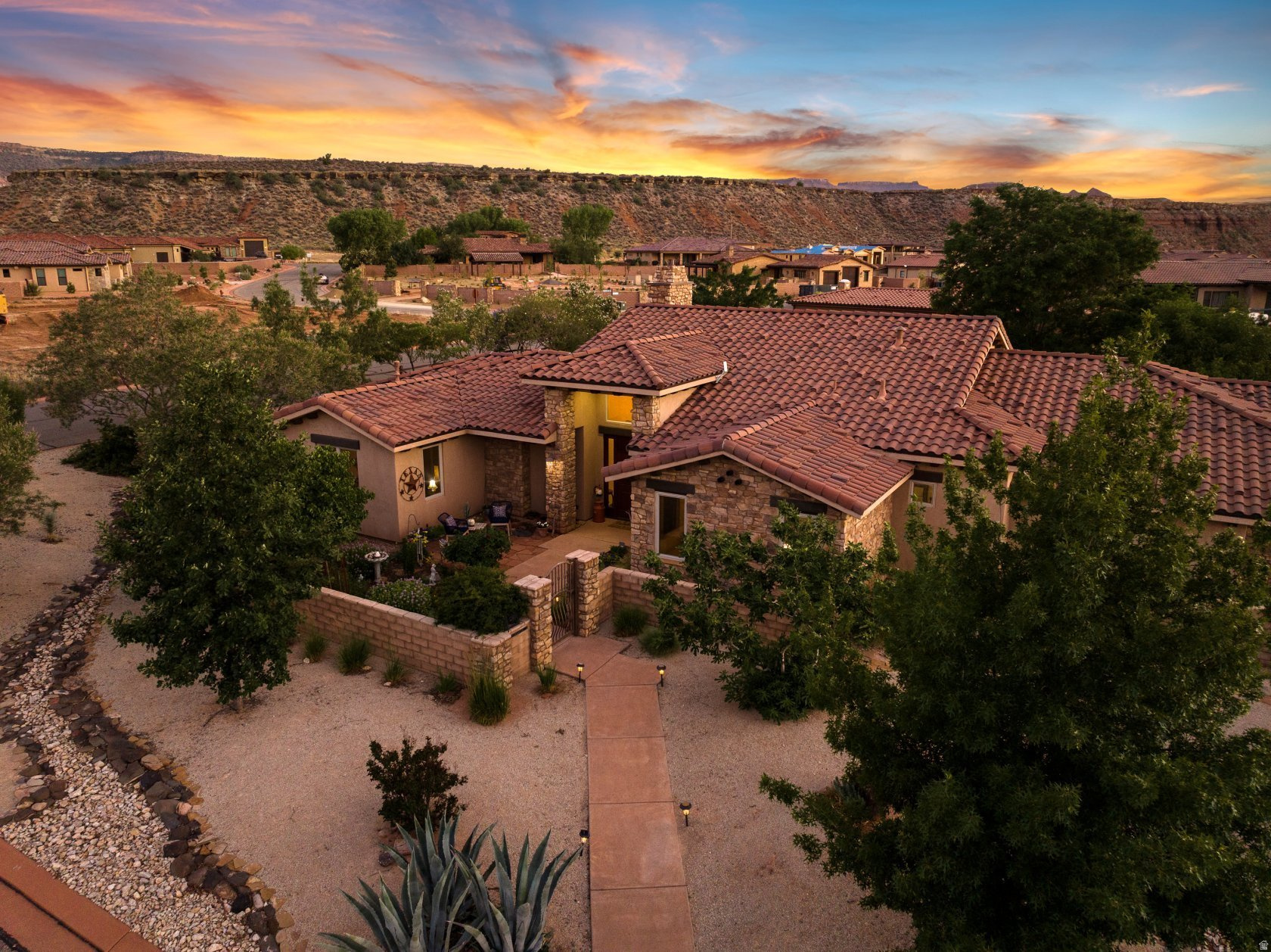 Nestled on over half an acre in the charming town of Virgin, Utah--just moments from the splendor of Zion Canyon--this custom-built residence offers a refined blend of indoor comfort and outdoor beauty. Beyond the private gate, a new privacy block wall and a landscape of fruit and nut trees, raised garden beds, and curated desert flora invites you to slow down and savor the seasons. Whether you're harvesting fresh figs for a summer tart or gathering herbs for a winter roast, the land here is as purposeful as it is picturesque. Inside, the 2,466-square-foot floor plan is graciously laid out, featuring three spacious bedrooms and three bathrooms--including two generous primary suites designed for rest and rejuvenation. High ceilings, natural light, and quality finishes throughout create a warm, welcoming atmosphere perfect for both quiet evenings and festive gatherings. The oversized garage including a separate workspace and storage room, provides ample space for storage and hobbies, while the nearby trails and canyons offer endless opportunities for exploration. Whether you're preparing fresh pasta in the well-appointed kitchen or enjoying morning tea on the patio with views of red rock cliffs, every moment in this home is a celebration of comfort, style, and simple pleasures. *Sellers circumstances have changed-All offers will be reviewed and responded by 5/5/2026.