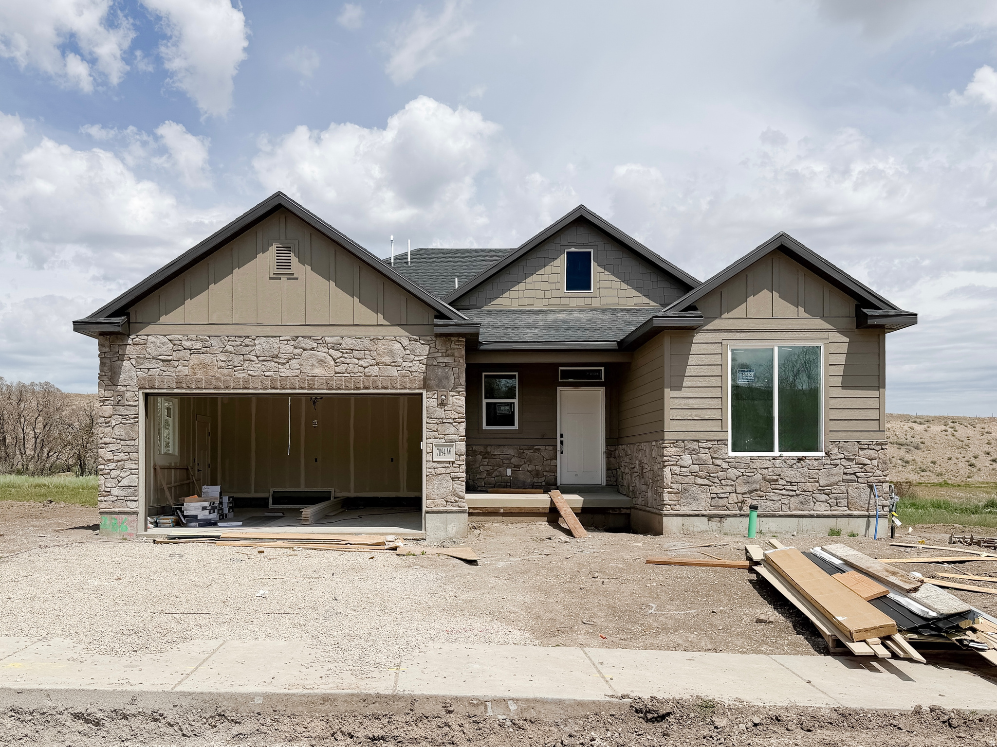 WOW! - $21,000 Lender Incentive, for this nearly completed home.  The home features a charming Craftsman-style exterior with covered front entrance.  Beyond the rear lot line is large open space with a community walking trail.  Inside you will find a gas fireplace, upgraded kitchen cabinets and vanity cabinets, upgraded countertops, and tankless water heater all included. The home offers three generously sized bedrooms with high peaked ceilings and two full bathrooms.  The primary suite is a standout with large walk-in closet, separate tub and shower and large vanity.  Front yard landscaping is included.  Be sure to ask about the $21,000 preferred-lender incentive.  Square footage figures are provided as a courtesy estimate only and were obtained from the builder.  Buyer is advised to obtain an independent measurement.  Additional homes and lots are available!