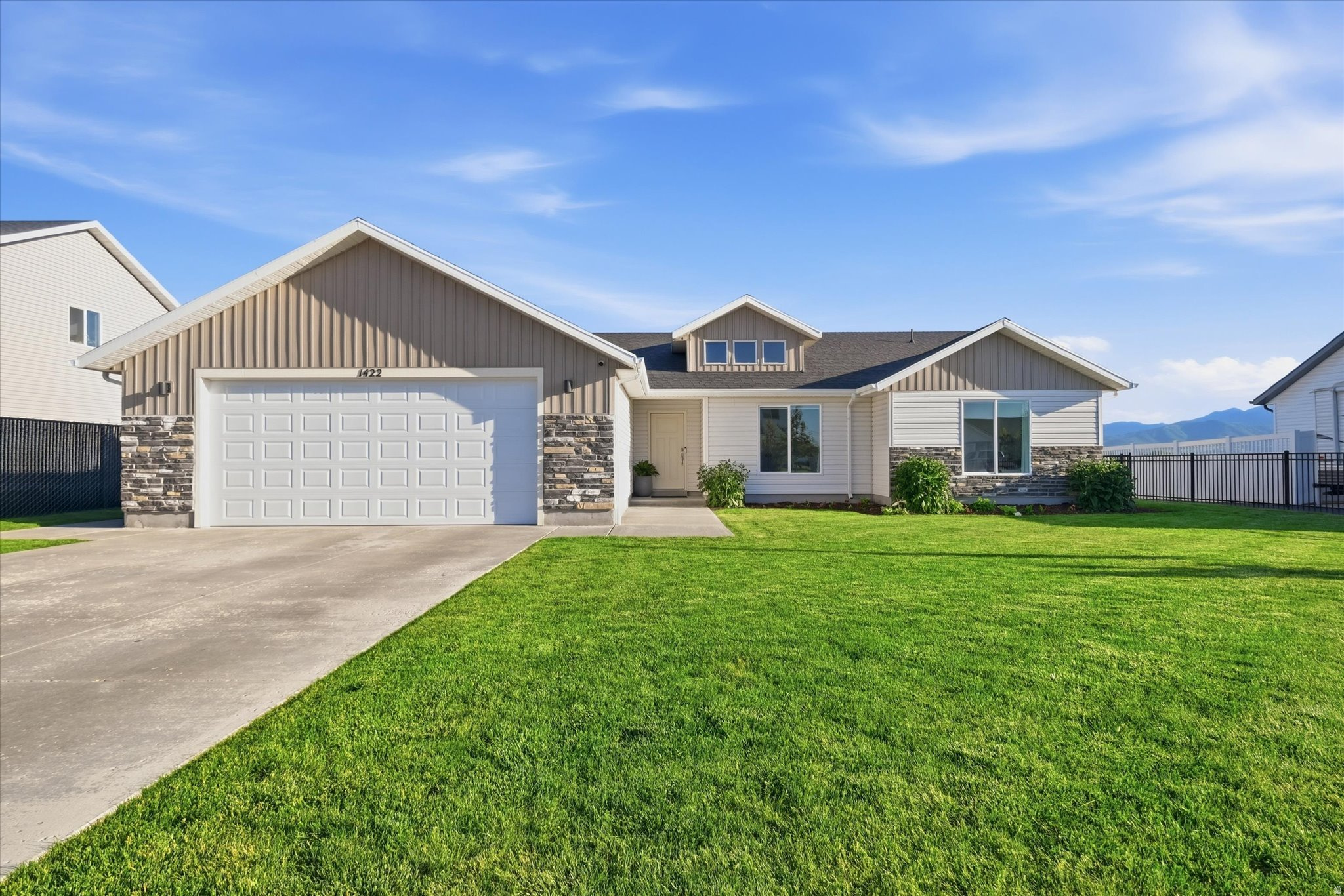 This 3 bedroom 2 bath home offers a like-new feel with the added benefit of established landscaping and a fully fenced backyard already in place. Enjoy the convenience of single-level living in this well-maintained home featuring an open floor plan and abundant natural light.  Large windows capture beautiful views of the Wellsville Mountains, providing a stunning backdrop throughout the year. Community walking paths offer easy access to outdoor recreation and exercise. Move-in ready and thoughtfully cared for, this property combines modern comfort, low-maintenance living, and scenic surroundings in an attractive package.