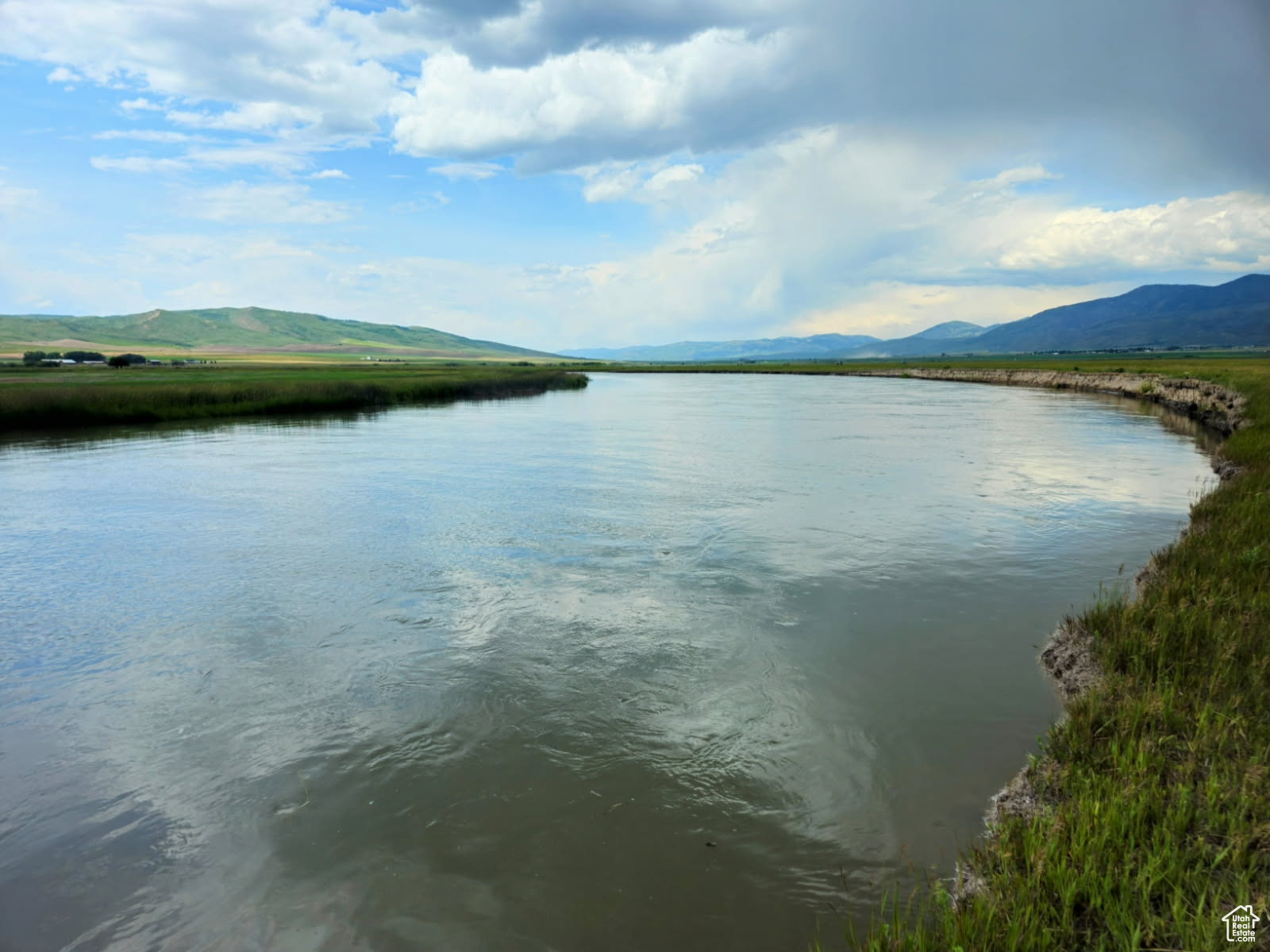 Rare opportunity to own an exceptional legacy ranch with extensive Bear River frontage, highly productive agricultural ground, and valuable water rights in one of southeastern Idaho's premier ranching regions. This impressive property combines strong agricultural production with outstanding natural beauty and long-term expansion potential.  The ranch features lush irrigated meadows supported by substantial water rights, including 4.0 CFS from the Bear River along with 15 shares of Montpelier Irrigation. Currently, approximately 215 acres are irrigated under two pivots, with sufficient water resources available to potentially more than double the existing irrigated acreage.  The Bear River runs for over one mile along the western boundary, providing reliable year-round stock water and enhancing the property's scenic and recreational appeal. Infrastructure has been thoughtfully developed for efficient livestock operations and includes multiple calving barns, corrals, hay covers, and a high-capacity fodder system capable of feeding more than 400 head of cattle per day.  This is a true turnkey ranching opportunity. The property may be purchased complete with approximately 200 head of cattle and existing equipment, or buyers may choose to purchase the real property only.  Whether you are seeking a productive working ranch, long-term agricultural investment, or multigenerational legacy property, this offering presents exceptional value and versatility.  Contact the listing agent today for additional information or to schedule a private showing.