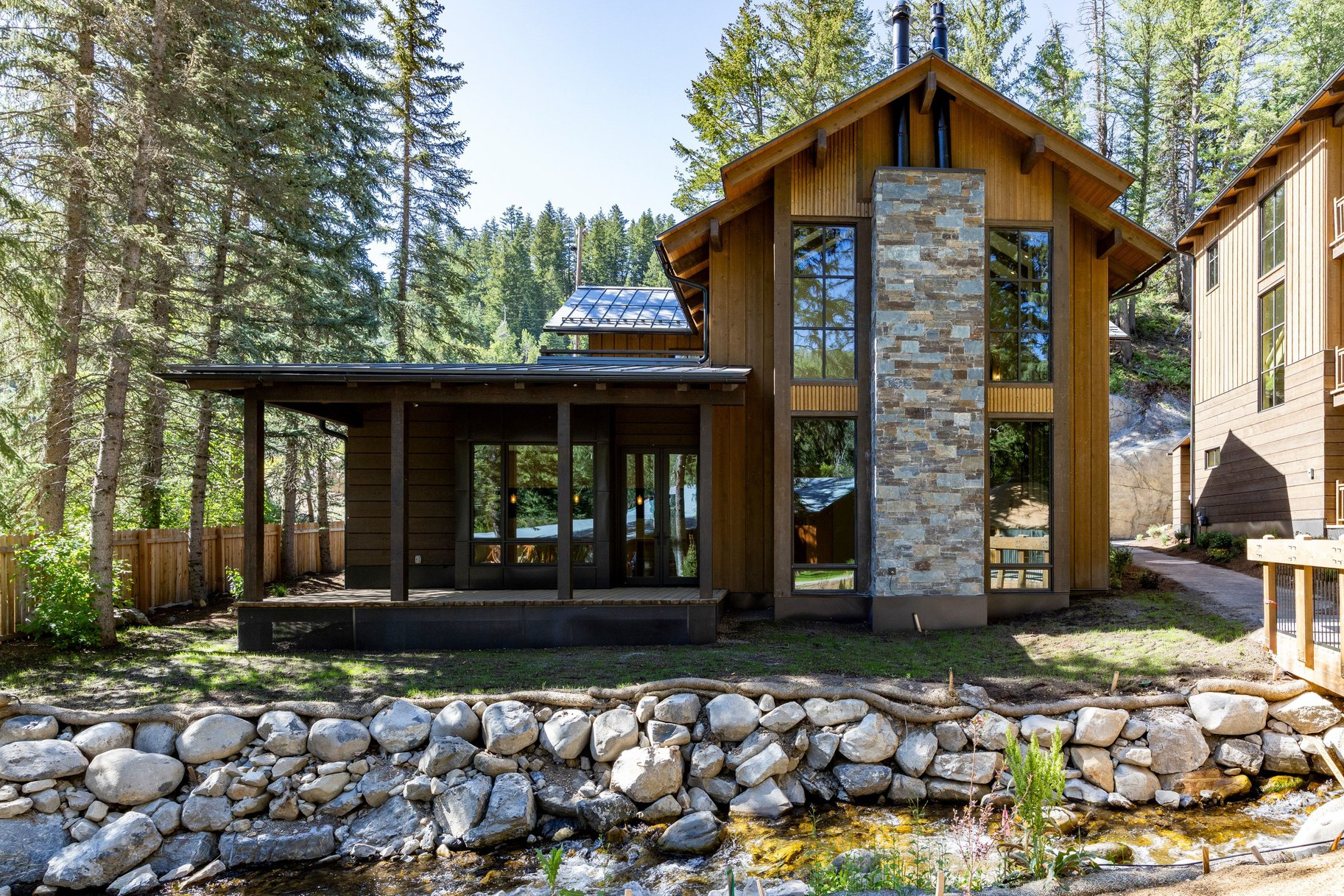 Positioned in the premier location at the base of Sundance Mountain Resort, this newly completed ski in/ski out residence is the only detached two-story home at the base of the resort and the largest of the six Village Homes. The home offers direct ski in and ski out access, with the North Fork stream flowing directly behind the residence while the lifts, restaurants, spa, art studio, screening room, and year-round activities of Sundance are all just a short walk away. Designed with a refined mountain contemporary aesthetic, the 3,532 square foot floor plan features four bedroom suites, an office, five bathrooms, expansive walls of glass, and warm wood and natural stone finishes. The main level is centered around a spacious great room and a beautifully appointed kitchen that opens directly to the covered deck overlooking the creek, while the upper level is anchored by a private primary suite with its own deck, luxurious bath, and walk in closet. The outdoor spaces make the property magical. Imagine hiking or skiing for a few hours and then spending the afternoon on one of the decks with the sound of the creek flowing just below, then walking a few minutes to dinner at the Foundry Grill before returning home beneath a canopy of stars. With its detached design, creekside setting, direct ski access, and unrivaled location within the Village Homes, this is a rare opportunity to own what is arguably the premier residence at Sundance Mountain Resort.