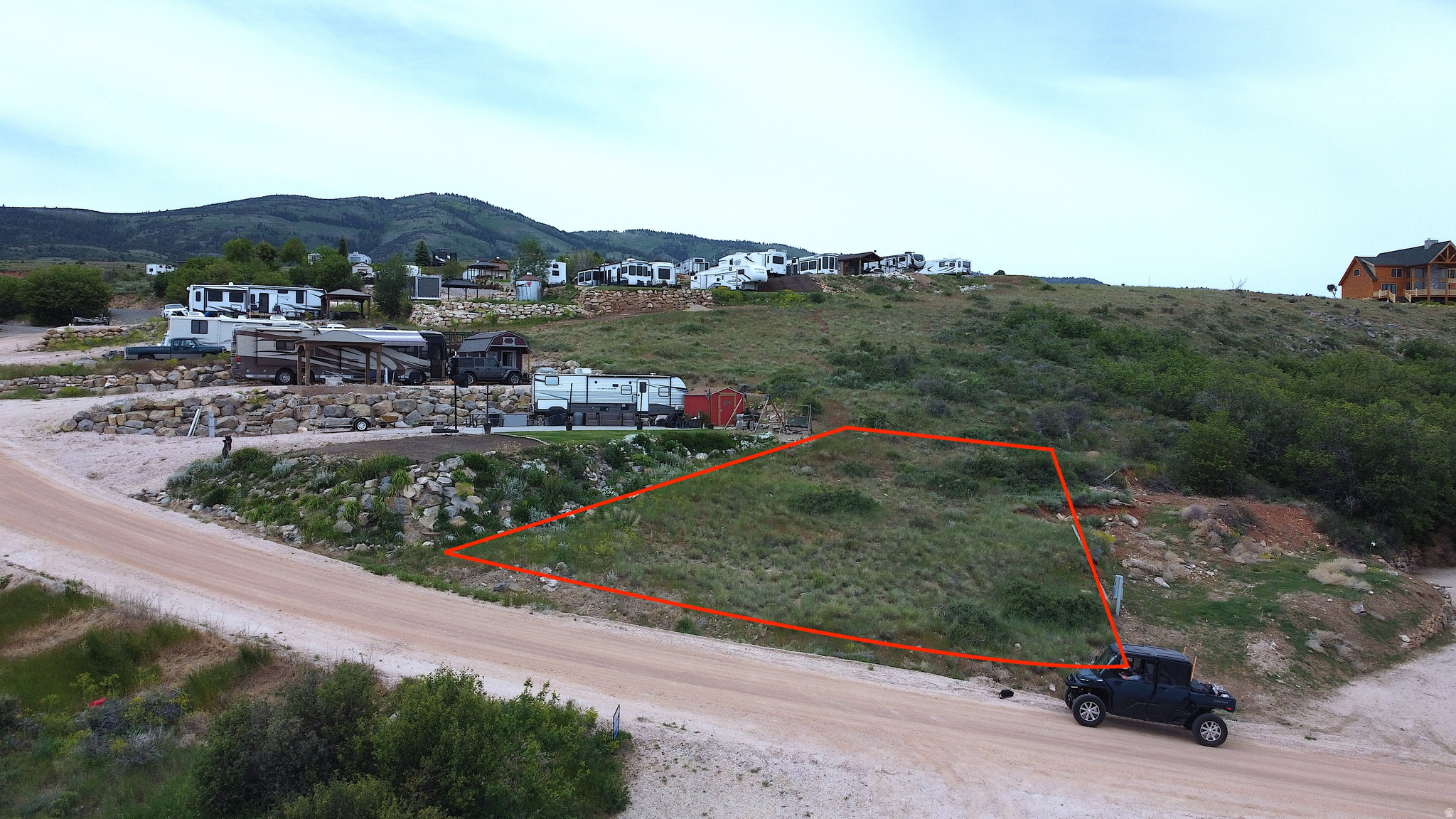 Discover a RV deeded lot that offers a breathtaking view of Bear Lake Marina, waiting for your creative vision. This 0.12-acre parcel comes equipped with water, power, and sewer connections. You'll be captivated by the expansive vistas of the lake and the western mountains of the valley, ensuring endless enjoyment. Come snag your Bear Lake Getaway today.