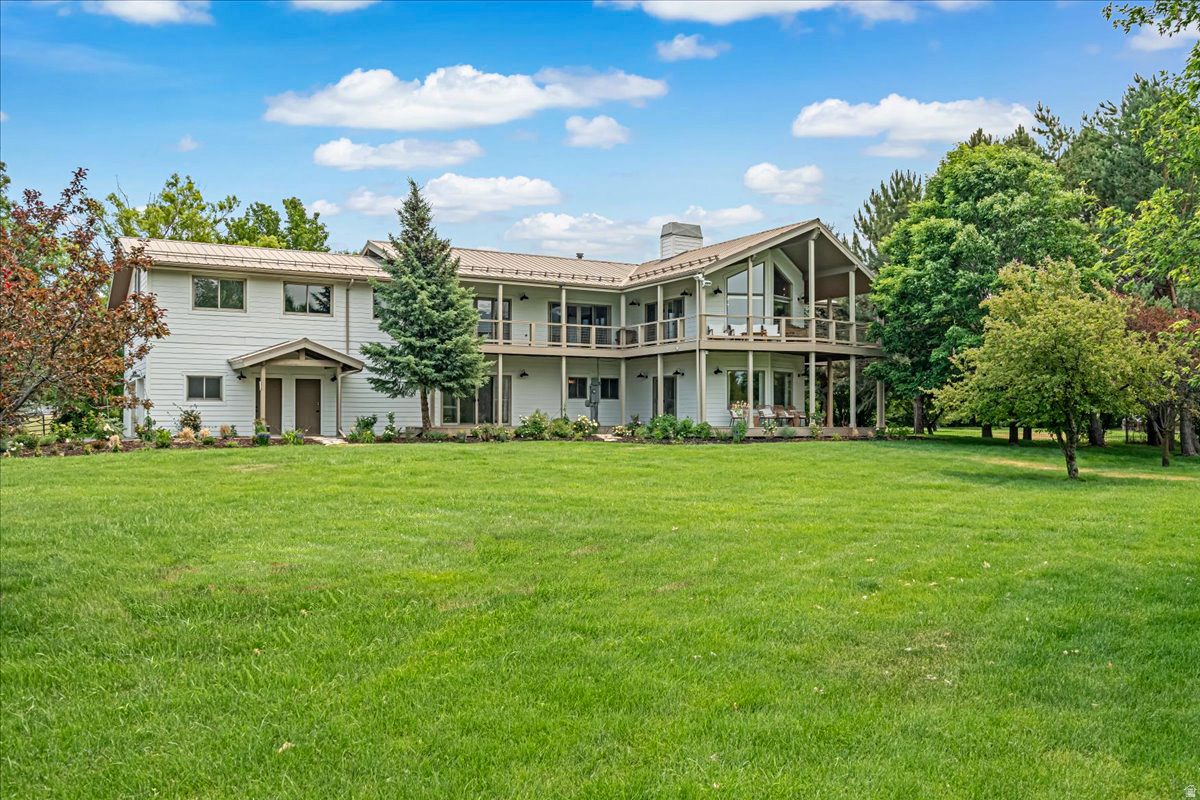 Private luxury retreat on 6 wooded acres with horse pasture, gardens, flat lawns, and a future barn site with room for toys, trailers, paddocks, and more. With plenty of water via Timp & Daniel shares, the property offers exceptional flexibility for equestrian use, hobby farming, or future improvements. The updated two-story home features 6 bedrooms, 5 baths, plus a fully separate 2-bedroom, 1-bath ADU ideal for guests, extended living, or rental income. Vaulted windows, abundant natural light, and 9 sliding doors that open to expansive decks overlooking the serene grounds. Complete with an updated kitchen, large butler's pantry, and 3-car garage, this private estate blends comfort, usability, and rare acreage.