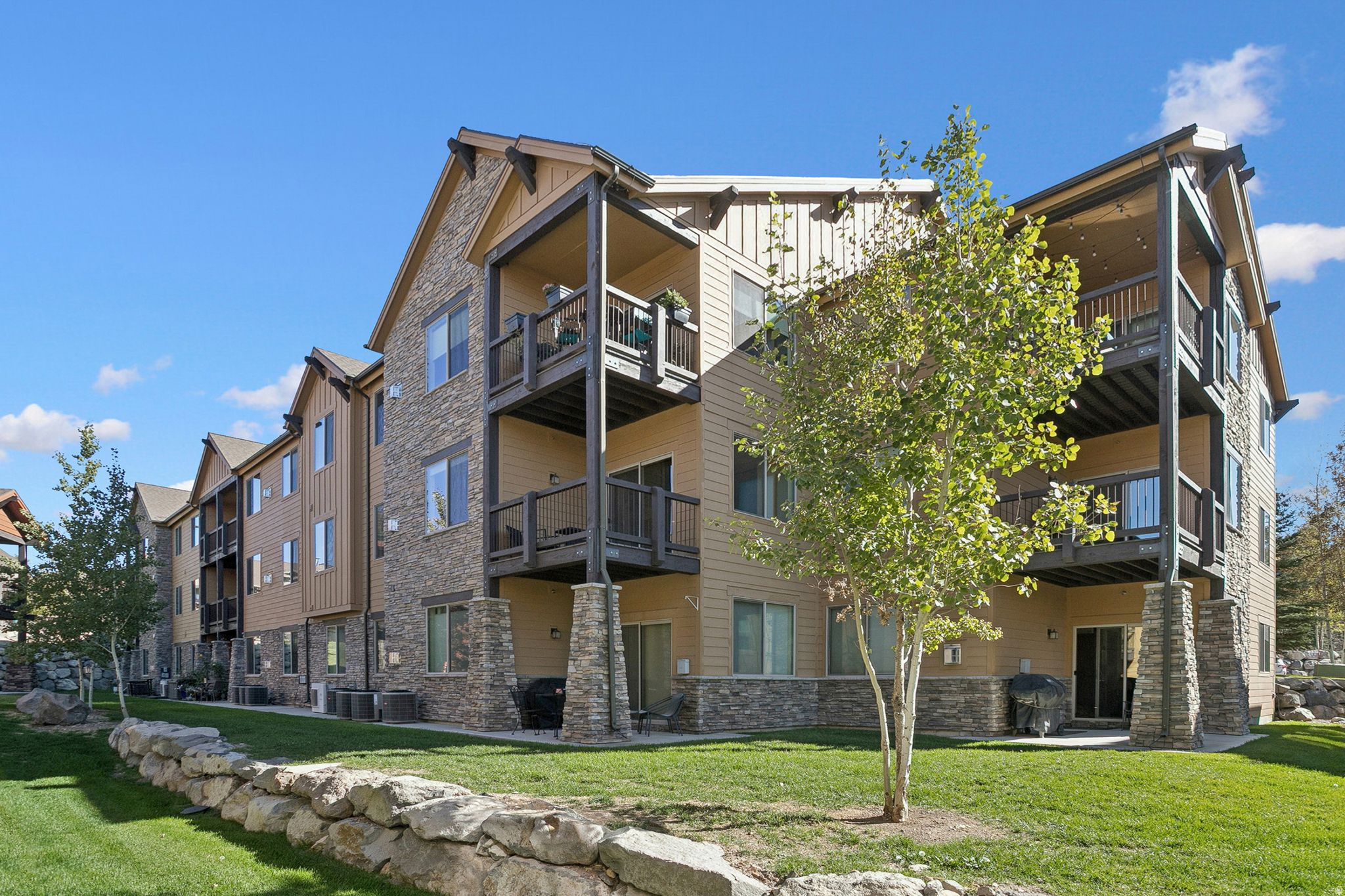 BLACK ROCK RIDGE - MAIN LEVEL - BEST OF THE BEST!  NO STAIRS, QUIET, RARE ATTACHED GARAGE!  Your dream mountain retreat awaits in the highly desirable Black Rock Ridge condos, where comfort, style, and adventure meet. This beautifully maintained 2-bedroom, 2-bath condo blends mountain-modern design with everyday convenience. Located on the main floor, the residence offers easy step-free access, making unloading groceries and daily living effortless. Positioned adjacent to interior open space, the unit enjoys a quiet and private setting. The open-concept living space is filled with abundant natural light and features a sun-filled great room with a cozy gas fireplace that flows seamlessly into the functional kitchen with stainless steel appliances and ample storage. Step onto the private balcony to take in peaceful mountain views or enjoy your morning coffee. The primary suite offers a walk-in closet and ensuite bath, while the second bedroom and full bath provide ideal space for guests, a home office, or flexible use. A rare, attached garage allows protected access to your vehicle during all seasons. Zoned for 7-night nightly rentals, this property is equally suited as a full-time residence, mountain getaway, or income-producing investment. Easy to get to Park City's Main Street, Deer Valley, Canyons Village, Jordanelle Reservoir, and scenic hiking and biking trails. HOA covers exterior maintenance, snow removal, landscaping, sewer, and trash for a true lock-and-leave lifestyle. Smart, stylish, and move-in ready, this home delivers the best of mountain living.