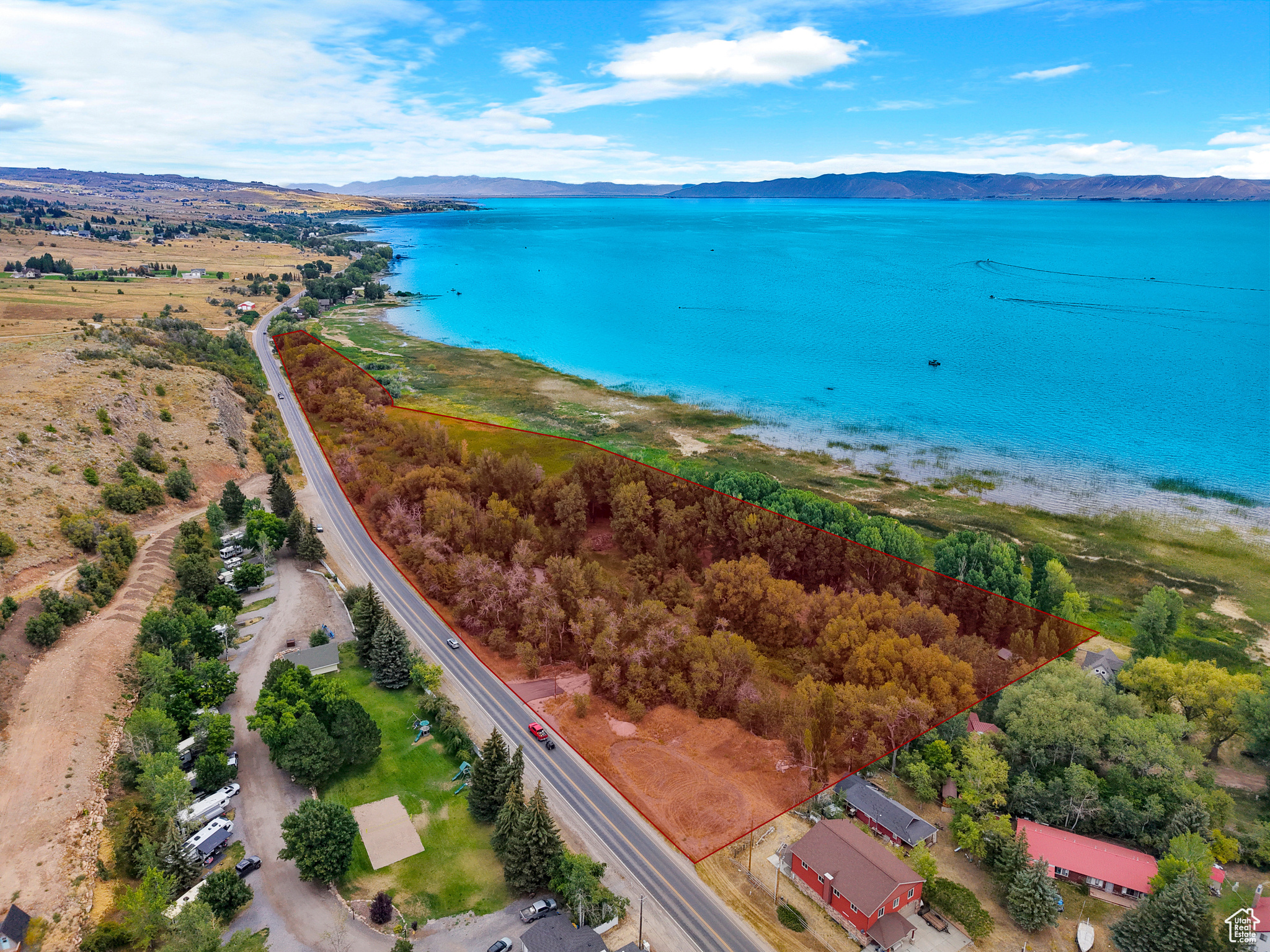 RARE Bear Lake Lakefront Opportunity! Discover 6.56 breathtaking acres with 2,139 feet of Bear Lake shoreline, located just north of Garden City. This one-of-a-kind property offers endless possibilities-an exceptional investment, private retreat, or unique development opportunity. The south 3.88 acres feature mature trees and serene ponds, ideal for creating a private lakefront estate or subdividing into multiple homesites. Preliminary approval is already in place for up to 6 lots, providing a valuable head start for development. The north 2.68 acres are protected by a permanent conservation easement, ensuring lasting privacy and preserving the natural beauty of the land. Located just minutes from Bear Lake Marina, shopping, and dining, this property perfectly blends seclusion, recreation, and prime lakefront access. Lakefront parcels of this size and quality are truly rare-don't miss this exceptional Bear Lake opportunity.