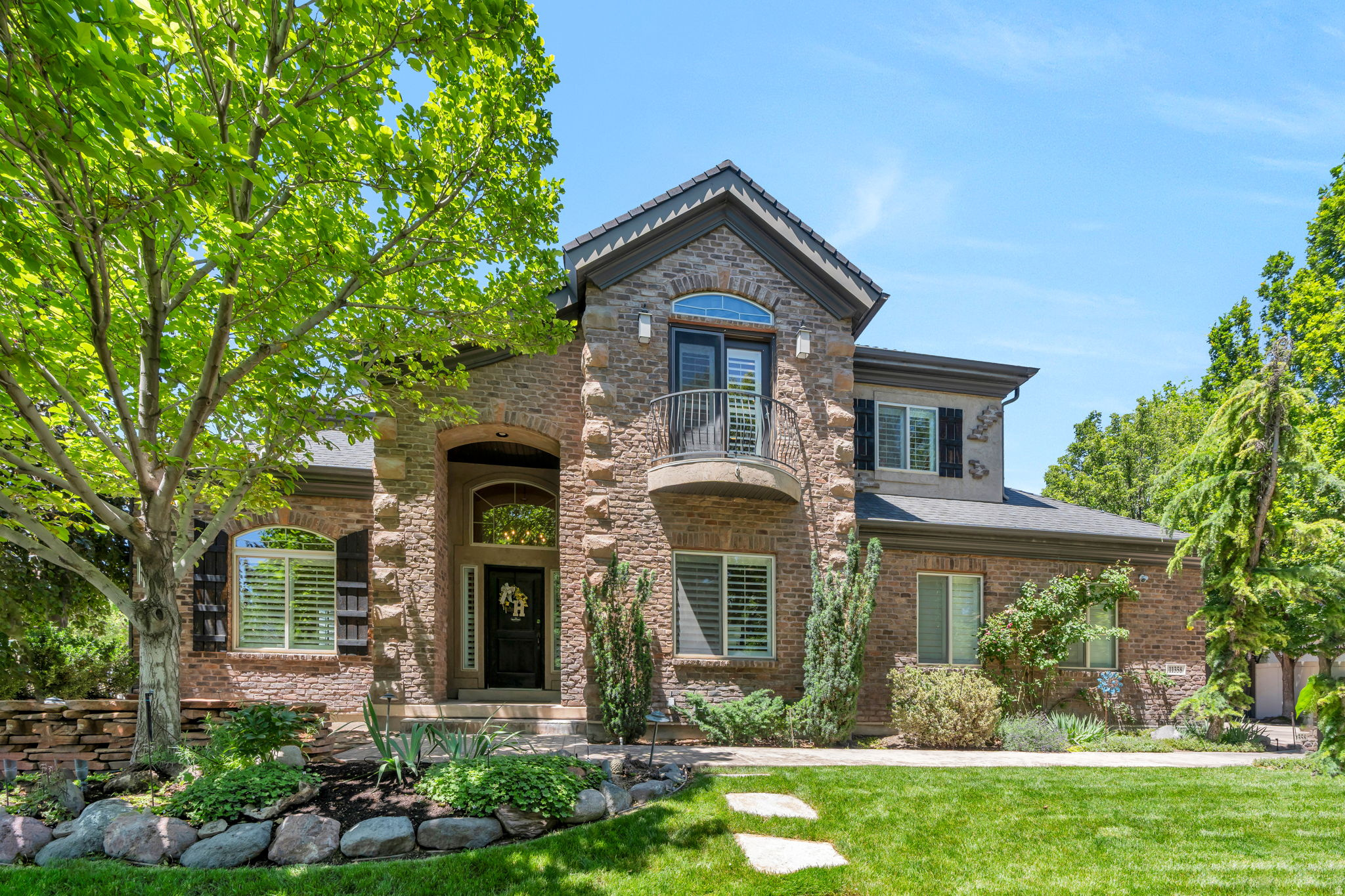 Tucked into one of South Jordan's most established neighborhoods, this meticulously maintained Ivory Crossing home offers a rare combination of privacy, mature trees, and quick access to Bangerter Hwy, I-15, shopping, dining, and everyday conveniences. Features include crown moulding, farmhouse shutters, surround sound, speakers throughout, functional security system, permanent exterior lighting, gutter guards, dual laundry hookups, and a new A/C condenser (2024). The backyard is beautifully maintained with a Trex deck and exceptional curb appeal. The standout feature is the incredible theater room beneath the suspended garage, complete with tiered seating for an authentic movie-night experience. Residents enjoy access to two pools, a reservable clubhouse, and one of the most desirable neighborhood settings in the area. Pride of ownership is evident throughout-this home has been exceptionally cared for and it shows. Square footage figures are provided as a courtesy estimate only and were obtained from county records. Buyer is advised to obtain an independent measurement.
