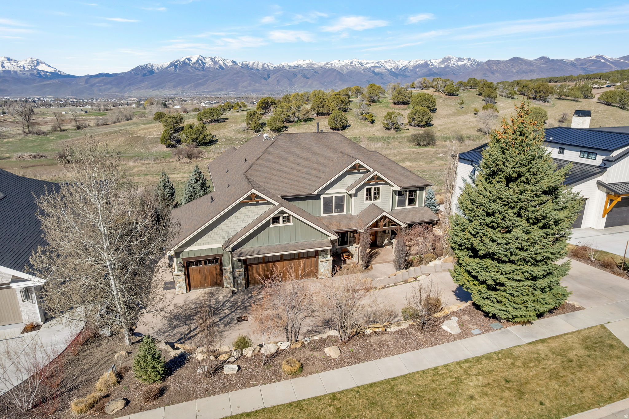 GREAT VALUE- Price reduction! Immaculate inside and out, has had one owner, with open floor plan, comfortable living areas, and heated driveway/ walkway. It is adjacent to acres of common area and has gorgeous unobstructed views of Mt. Timpanogos. Two primary bedroom suites, lower level family room, deluxe wet bar has dishwasher and frig, home theater, fitness room, multiple play areas, beautiful entry and office/ den, designer details in every room, hot tub, audio system, and expansive back decks that overlook the valley and local elk, geese and deer.  Perfect for multi-generational family reunion home, or primary residence. Acreage and sq.ft. source is appraisal. Square ft is different on public records, buyer to verify ALL info to buyer's own satisfaction.