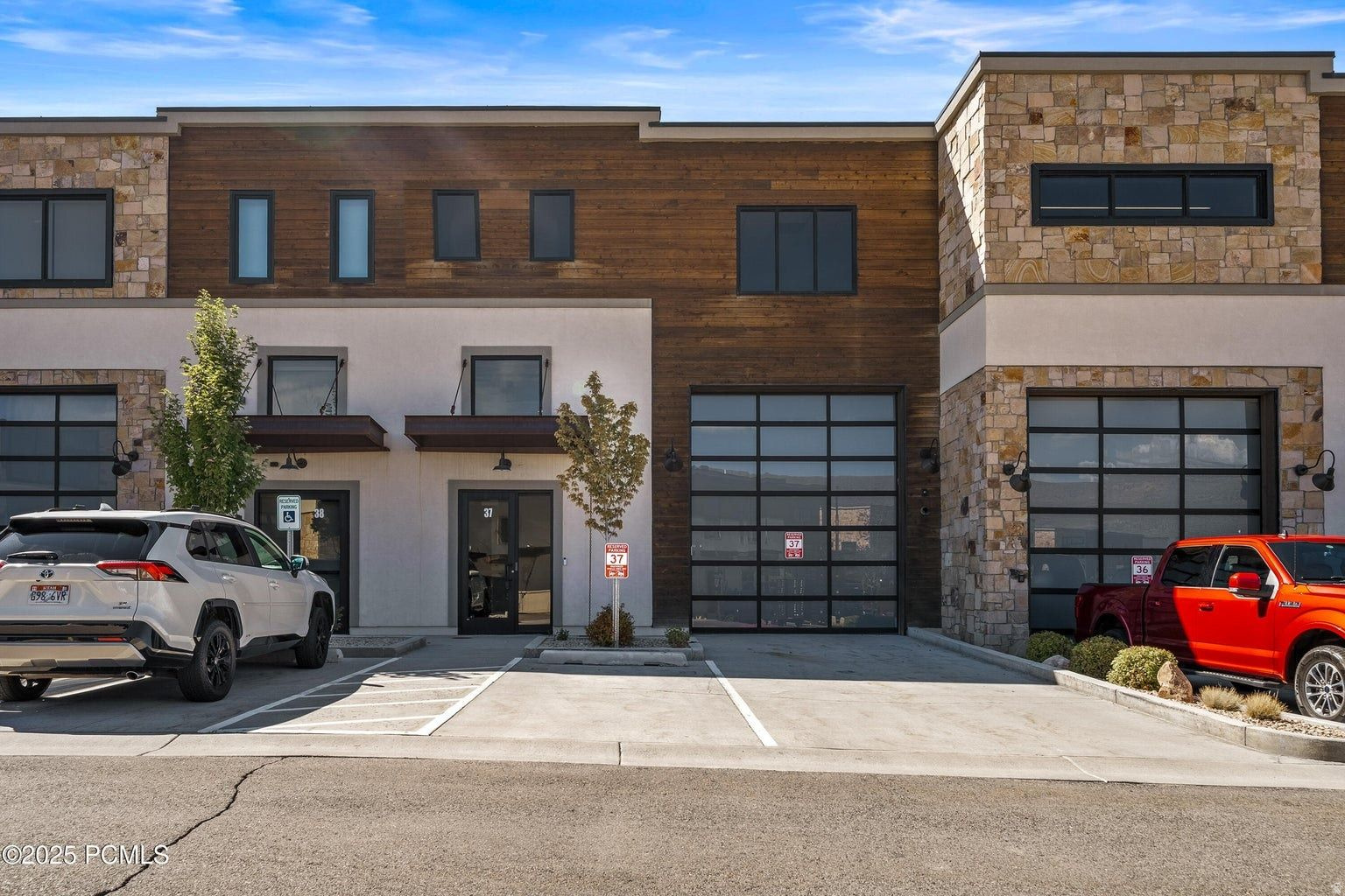 Welcome to Unit #27 at Park East II, a brand-new, never-occupied live/work business condo offering exceptional flexibility for entrepreneurs, professionals, and outdoor enthusiasts looking to combine workspace, storage, and residential living in one location. This thoughtfully designed two-level unit features an expansive main-level workspace with a 14- foot glass garage door and high-clearance access, ideal for boats, RVs, trailers, equipment, or additional vehicles. The main floor also includes a full bathroom with shower and a break room with kitchenette. The fully finished second level (approximately 1,227 SF) can function as a one-bedroom apartment, executive office suite, or collaborative workspace, complete with a full bathroom, break room, and open office layout. The upper level can also be configured as a lock-off space, offering potential for additional tenants or employee housing. Located on the quiet south end of the Park East II development, Unit #27 offers a more private setting just minutes from Kimball Junction, world-class skiing, and year-round outdoor recreation, making it the perfect place to work, live, and play in Park City.