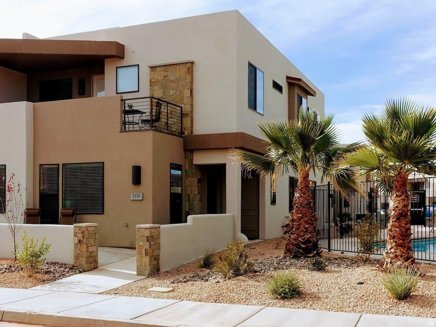 This spacious home, zoned for short-term rentals and sold turn-key, is fully furnished and has a functioning STR business. In an ideal location, this home is conveniently next to the pool. It includes 2 private balconies, one with a private hot tub. This home features several large open areas that allow groups to eat, meet, and enjoy time together while still having private master bedrooms with king beds. The home has 4 bedrooms and 4.5 bathrooms, accommodating 10+ guests. Oversized deck with private hot tub included overlooks resort pool. This is the perfect place for families, large groups, or corporate trips. Located just 30 minutes from Zion National Park, minutes from Sand Hollow, multiple golf courses, and endless outdoor adventures. Airbnb has multiple 5-star reviews and guest-favorite status.