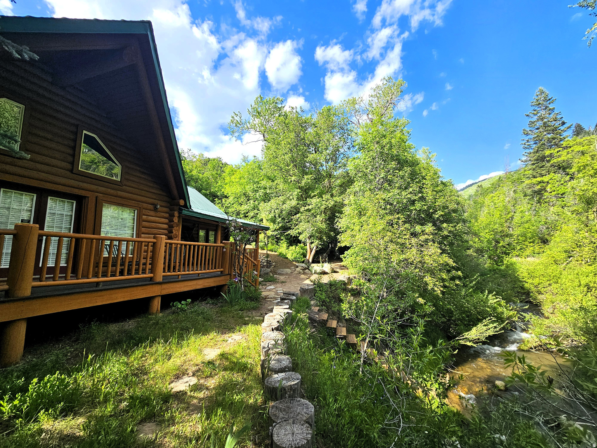 Beautiful handcrafted log cabin in immaculate condition, nestled directly on Birch Creek with pine, aspen, and cottonwood trees! Enjoy the sound of living next to a creek and waterfalls with running water year-round in beautiful mountains with easy access. Single-level living with a spacious primary suite, with direct access to the deck, overlooking the creek. Cabin is being sold fully furnished with beautiful, valuable antiques. It is loaded with furniture and decorations befitting a true log cabin and mountain setting. Don't miss the working antique pioneer stove in the kitchen, the clawfoot tub in the primary suite, and many other unique furnishings. Cabin features a large open loft with plenty of space for games and several beds. Over 5.8 acres spread out on two lots. Cabin includes a two-car detached metal garage, highly engineered to withstand heavy snow load, wired with power, and located approximately 75 feet from cabin. Can be used for vehicles, as a workshop, or a perfect place to store your motorized toys. This cabin is the perfect location, with easy access along a well-maintained road two miles up a scenic canyon between Fairview and Mt. Pleasant, and less than one hour from Utah County. Enjoy your very own cabin property nestled in a mountain resort with cool, crisp mountain air, and get away from it all. Skyline Mountain Resort has so many activities from a swimming pool, pickleball, and tennis to a 9-hole golf course. Enjoy the Manti-La Sal National Forest and all that Skyline Drive has to offer close by: hunting, fishing, lakes, hiking, exploring, hundreds of miles of ATV trails and similar terrain for snowmobiles and winter recreation. Also, just a few minutes from all the small-town amenities like a hospital, hardware and grocery stores, community indoor swimming pool, museums, and even a drive-in theater. Controlled community gate entrance. Power is connected and the property has a septic system. Water is from a nearby community fill station or from a share you own. Elevation is 6,818 feet. MLS map is correct. Google Maps/Earth is 39.59257, -111.37293. Square footage figures are provided as a courtesy estimate only and were obtained from the county. Buyer is advised to obtain an independent measurement and to verify information in the listing. **View a video tour of the cabin at: https://youtu.be/aSqO7-i2g3w