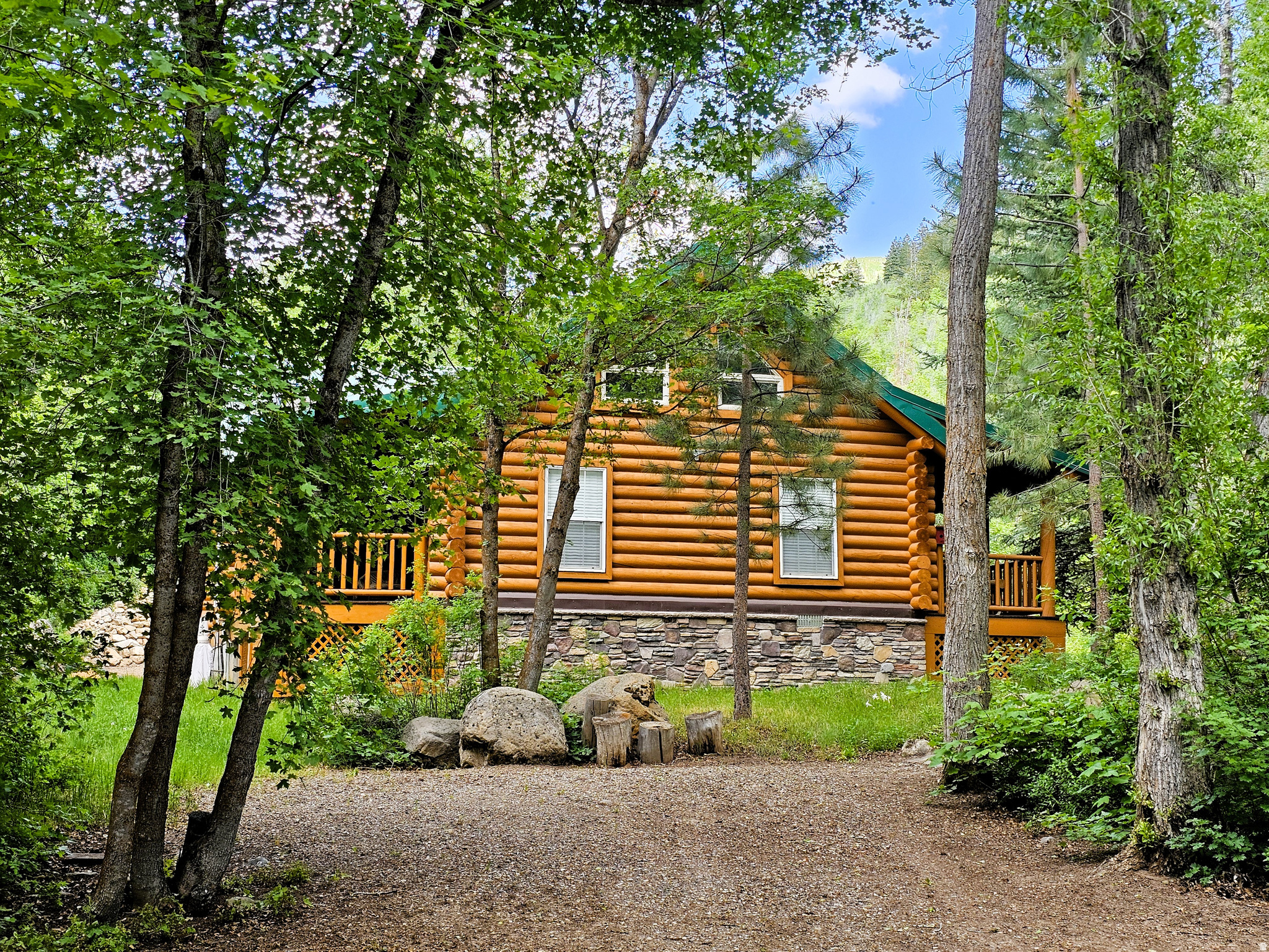 Beautiful handcrafted log cabin in immaculate condition, nestled directly on Birch Creek with pine, aspen, and cottonwood trees! Enjoy the sound of living next to a creek and waterfalls with running water year-round in beautiful mountains with easy access. Single-level living with a spacious primary suite, with direct access to the deck, overlooking the creek. Cabin is being sold fully furnished with beautiful, valuable antiques. It is loaded with furniture and decorations befitting a true log cabin and mountain setting. Don't miss the working antique pioneer stove in the kitchen, the clawfoot tub in the primary suite, and many other unique furnishings. Cabin features a large open loft with plenty of space for games and several beds. Over 5.8 acres spread out on two lots. Cabin includes a two-car detached metal garage, highly engineered to withstand heavy snow load, wired with power, and located approximately 75 feet from cabin. Can be used for vehicles, as a workshop, or a perfect place to store your motorized toys. This cabin is the perfect location, with easy access along a well-maintained road two miles up a scenic canyon between Fairview and Mt. Pleasant, and less than one hour from Utah County. Enjoy your very own cabin property nestled in a mountain resort with cool, crisp mountain air, and get away from it all. Skyline Mountain Resort has so many activities from a swimming pool, pickleball, and tennis to a 9-hole golf course. Enjoy the Manti-La Sal National Forest and all that Skyline Drive has to offer close by: hunting, fishing, lakes, hiking, exploring, hundreds of miles of ATV trails and similar terrain for snowmobiles and winter recreation. Also, just a few minutes from all the small-town amenities like a hospital, hardware and grocery stores, community indoor swimming pool, museums, and even a drive-in theater. Controlled community gate entrance. Power is connected and the property has a septic system. Water is from a nearby community fill station or from a share you own. Elevation is 6,818 feet. MLS map is correct. Google Maps/Earth is 39.59257, -111.37293. Square footage figures are provided as a courtesy estimate only and were obtained from the county. Buyer is advised to obtain an independent measurement and to verify information in the listing. **View a video tour of the cabin at: https://youtu.be/aSqO7-i2g3w